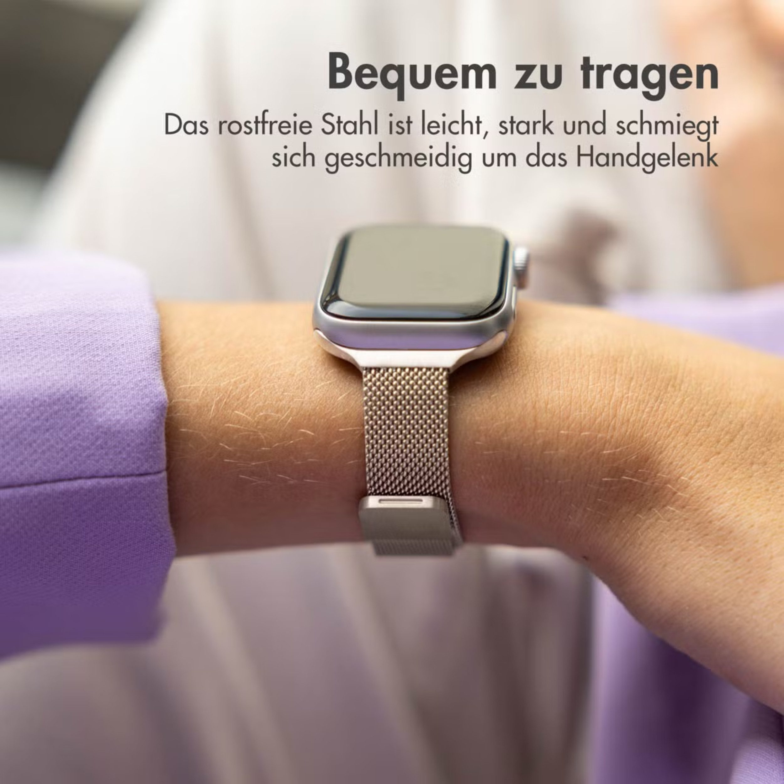 Eine Person trägt eine silberne Smartwatch mit einem Edelstahlarmband am Handgelenk.