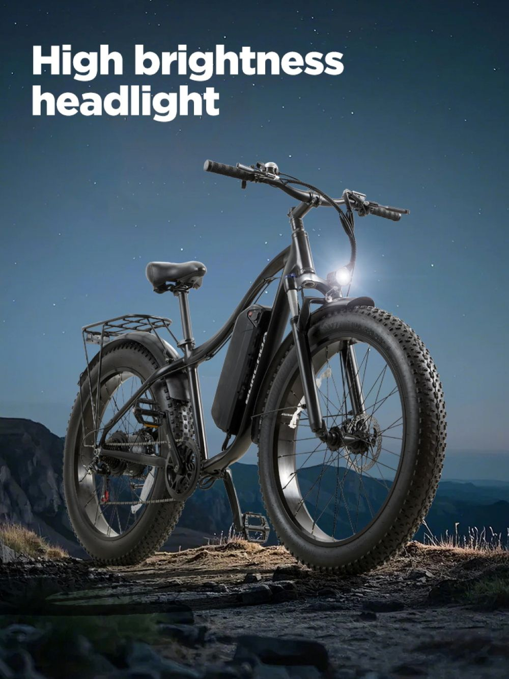 Una e-bike nera con pneumatici grassi si trova all'aperto di notte sotto un cielo stellato.