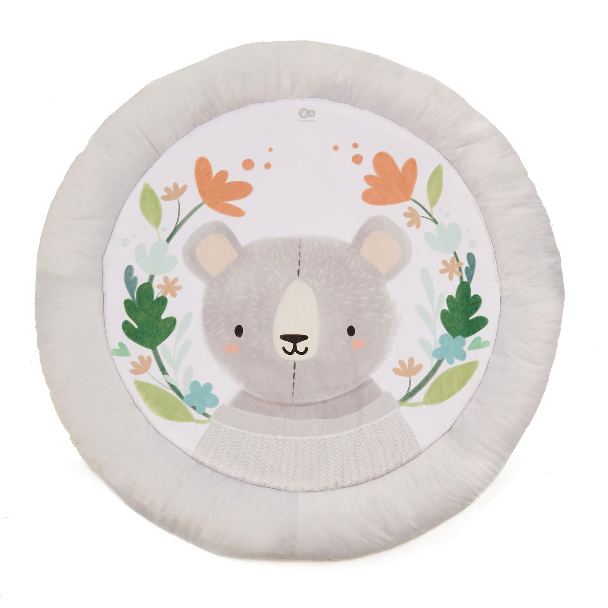 Ein grauer Teddybär mit Blumen und Blättern auf einer runden Spielmatte.