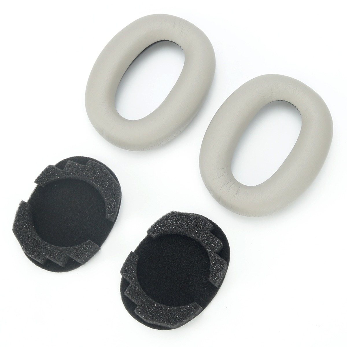 Dos almohadillas grises y dos almohadillas de espuma negras sobre fondo blanco.