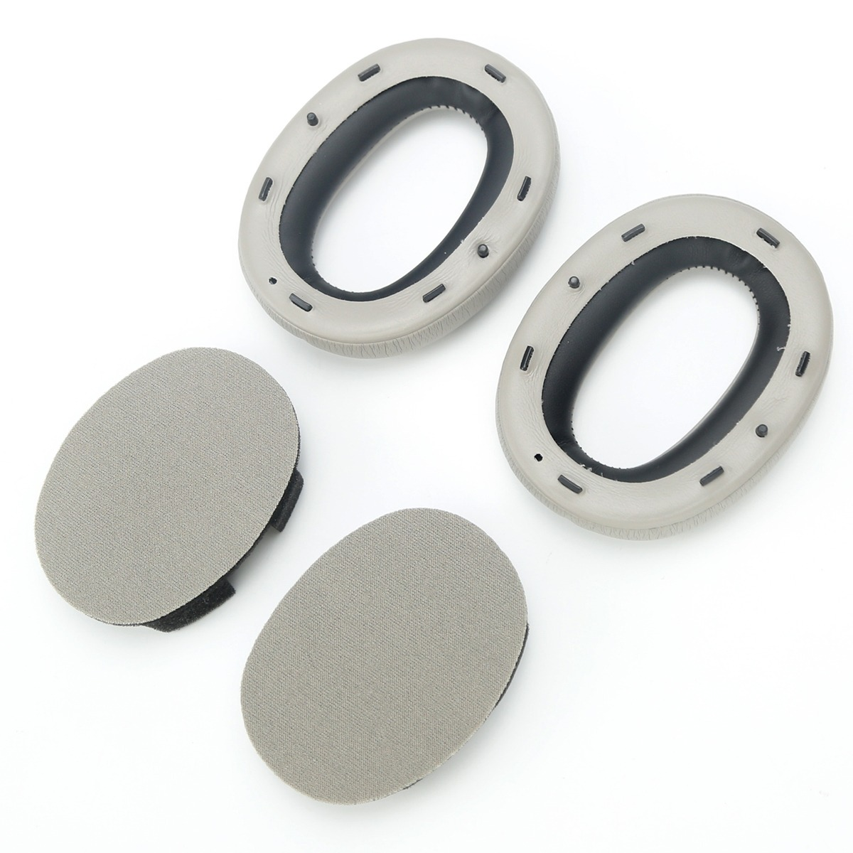 Dos almohadillas ovaladas y dos inserciones redondas en gris sobre fondo blanco.