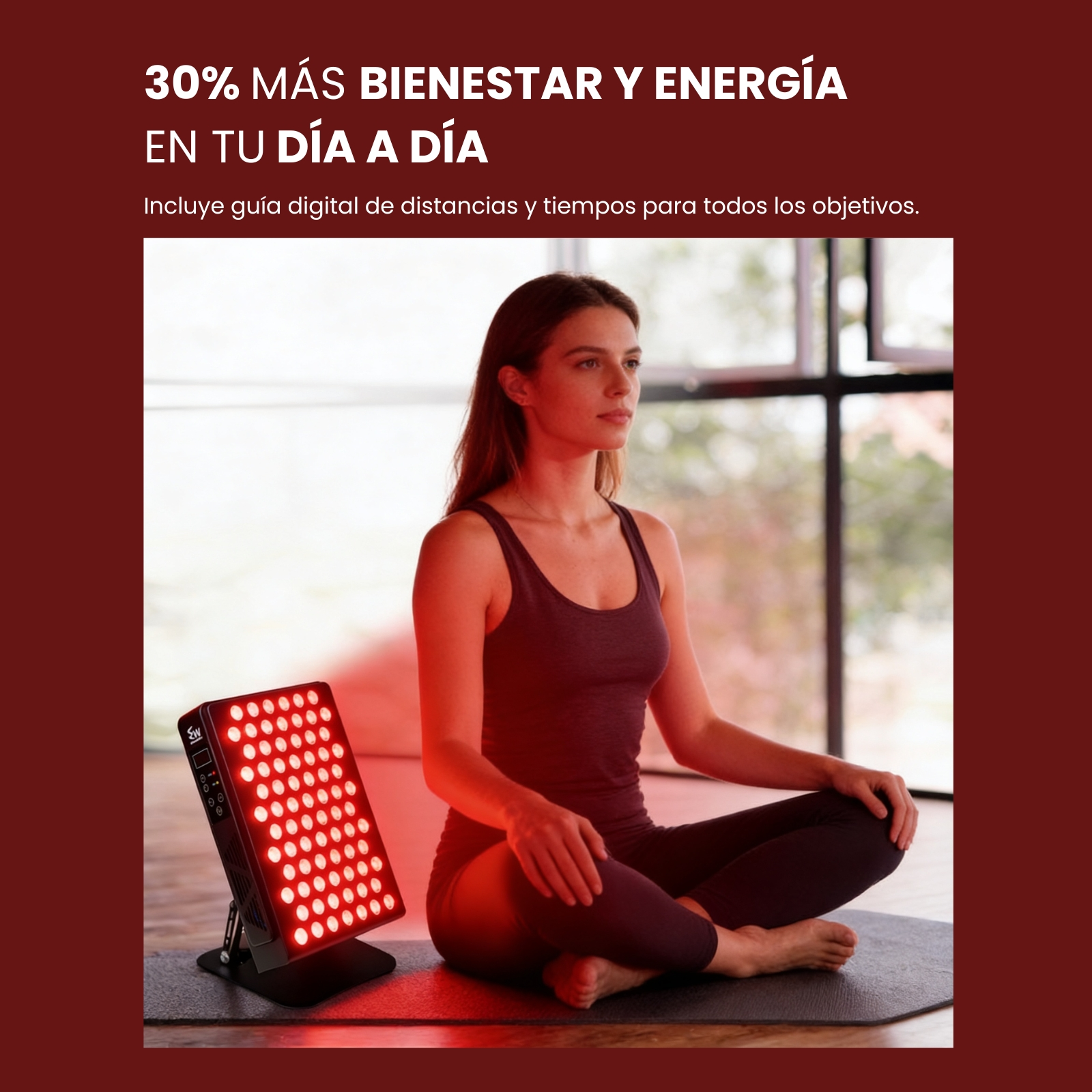 Una mujer sentada en posición de loto frente a un dispositivo de luz roja.