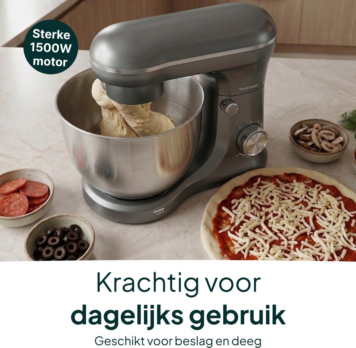 Gray stand mixer with dough in bowl, pizza and ingredients nearby.