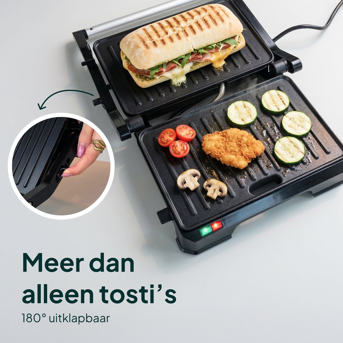 A contact grill with a sandwich, chicken, tomatoes, mushrooms, and zucchini.