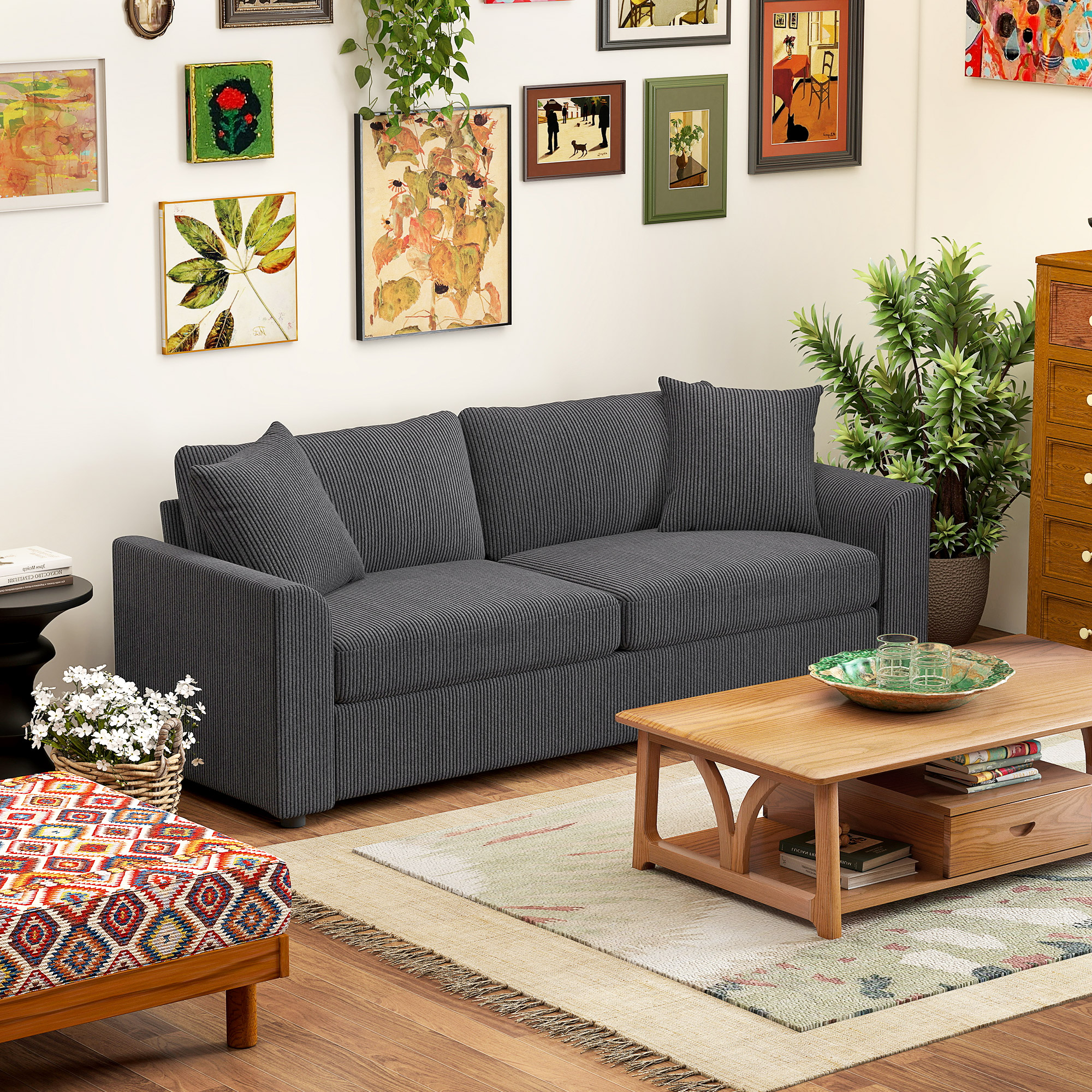 Un sofá de pana gris oscuro con cojines se encuentra en una habitación con arte y mesa de centro.