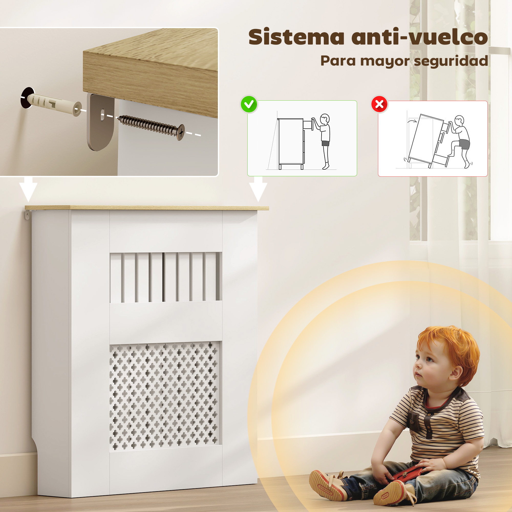 Un niño pequeño se sienta cerca de un gabinete blanco asegurado con un dispositivo antivuelco.