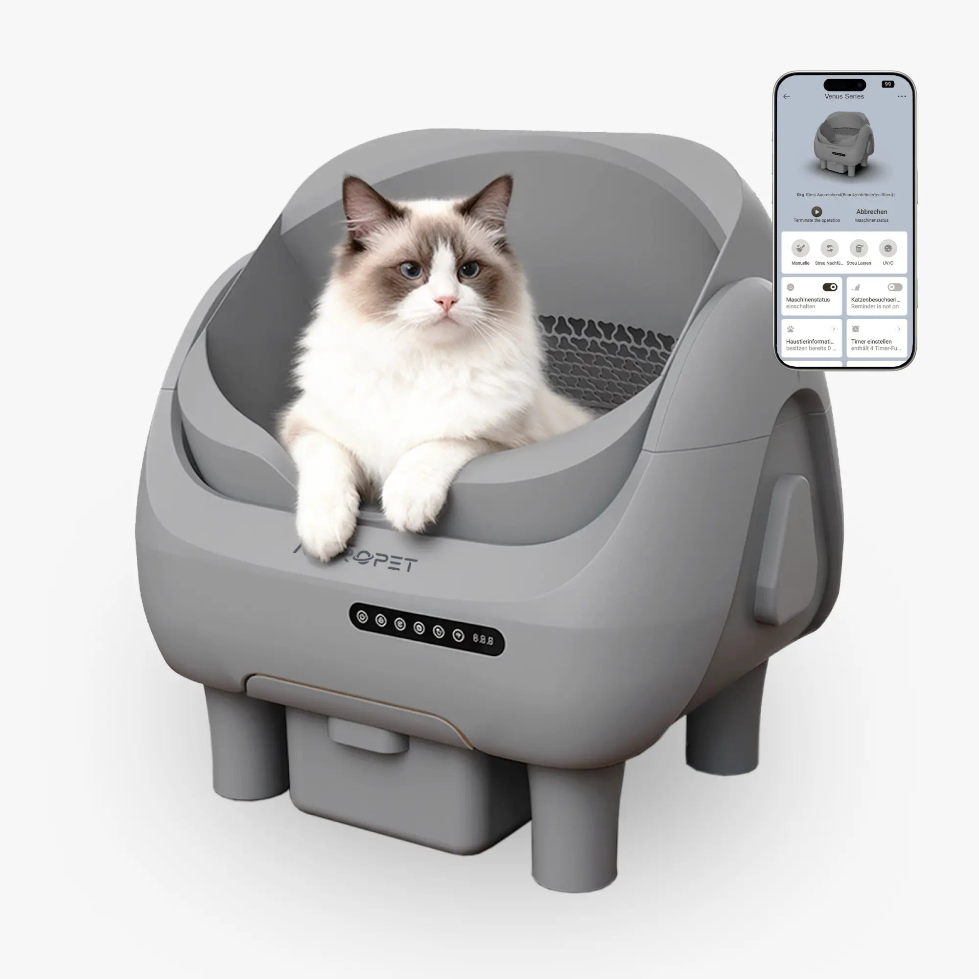 Eine Katze sitzt in einer grauen selbstreinigenden Katzentoilette mit einem Smartphone daneben.