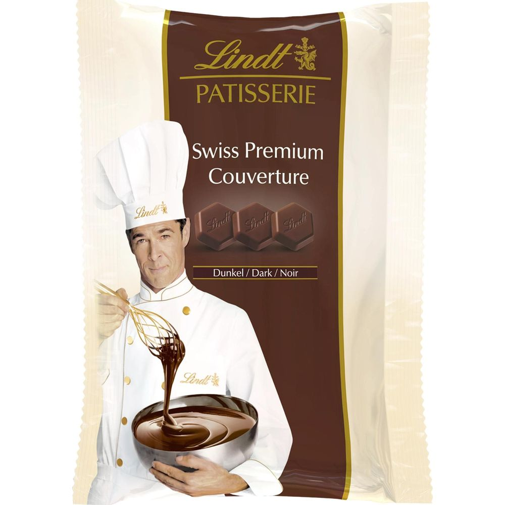 Uno chef con cappello da cuoco frusta cioccolato fuso in una ciotola.