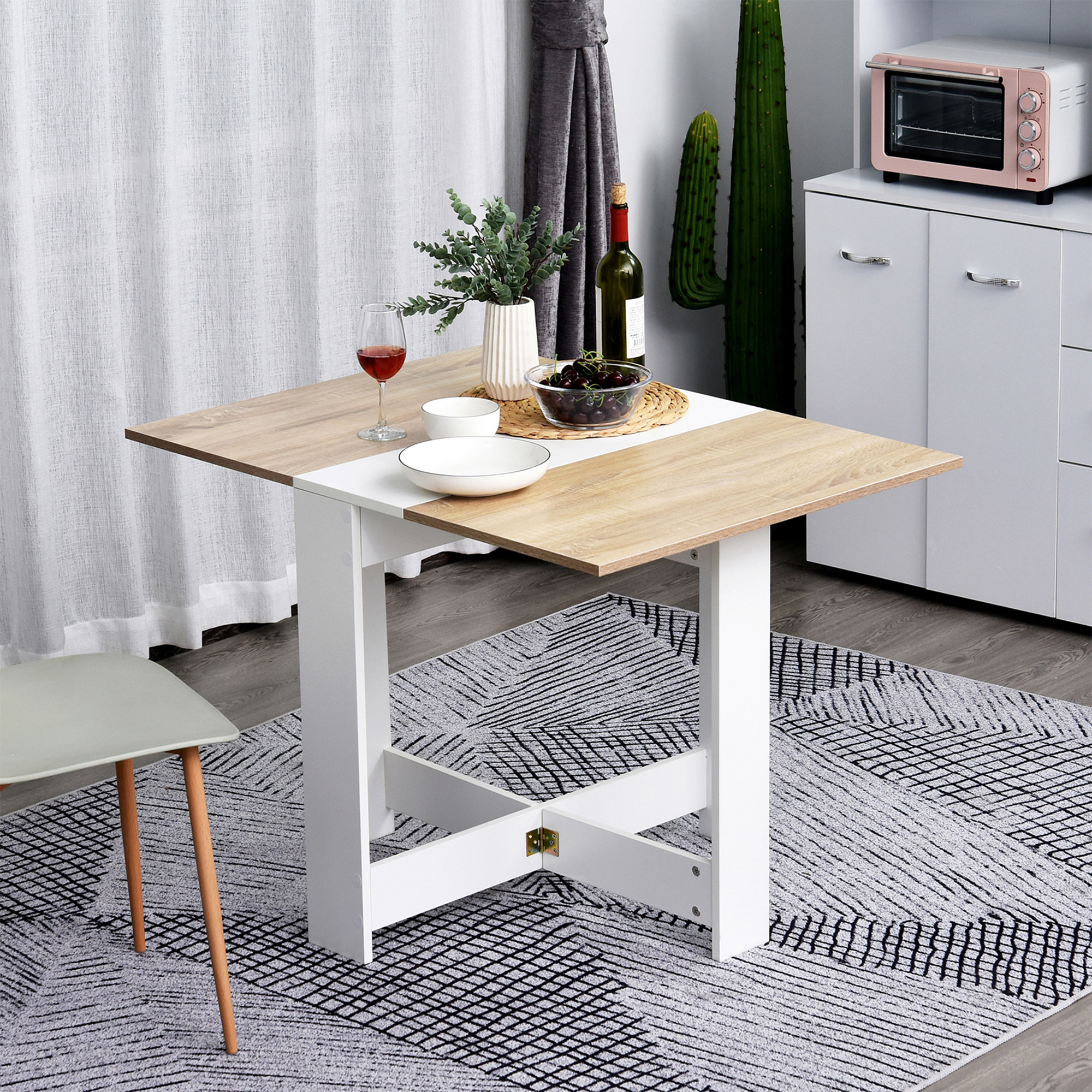 Mesa plegable con tablero de madera, copa de vino, frutero y mini horno.