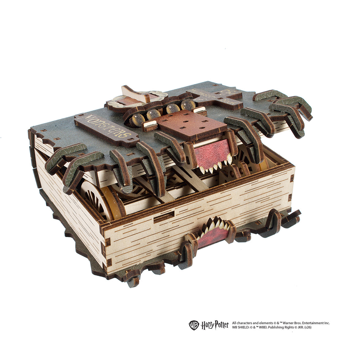 Ein hölzernes Modell eines Monsterbuchs, das aufgeschlagen ist und Zähne zeigt.