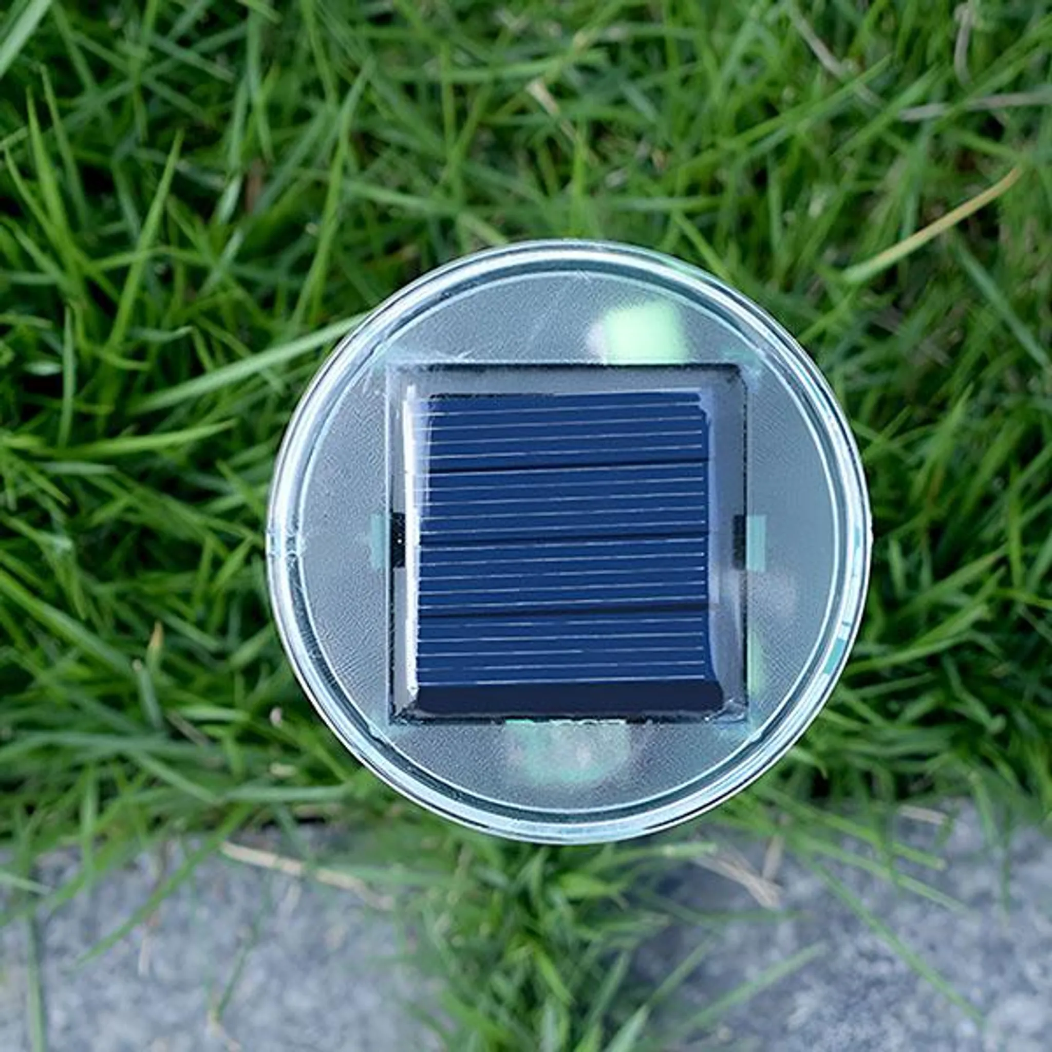 Solarpanel in einer runden Hülle auf grünem Gras.