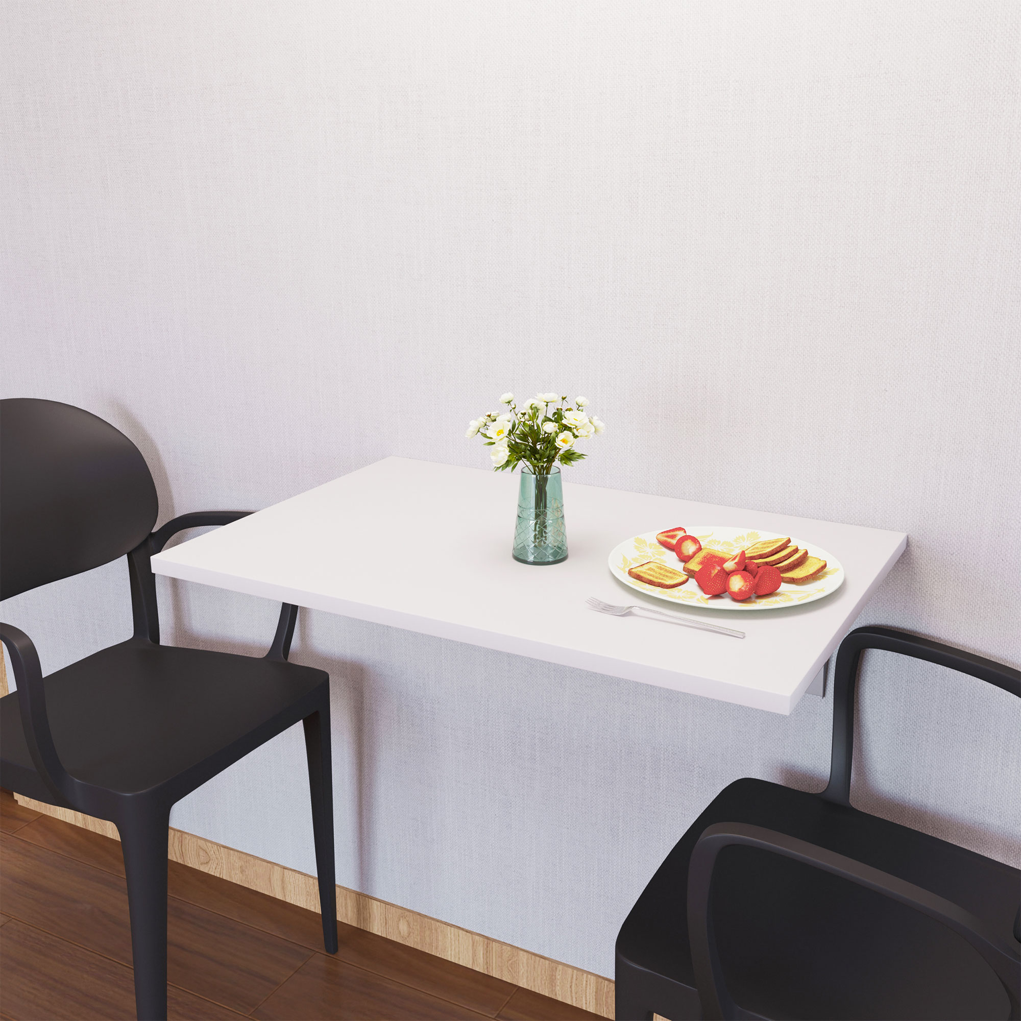 Una mesa plegable blanca con comida y flores, junto a sillas negras.