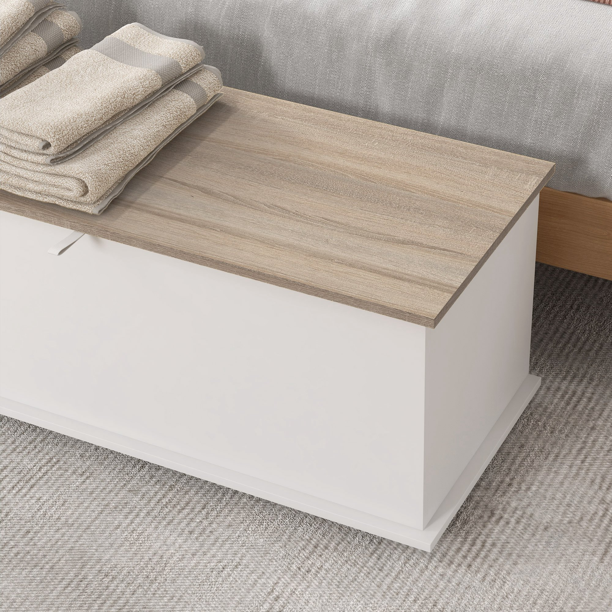 Banqueta de almacenamiento blanca con tapa de madera y toallas apiladas.