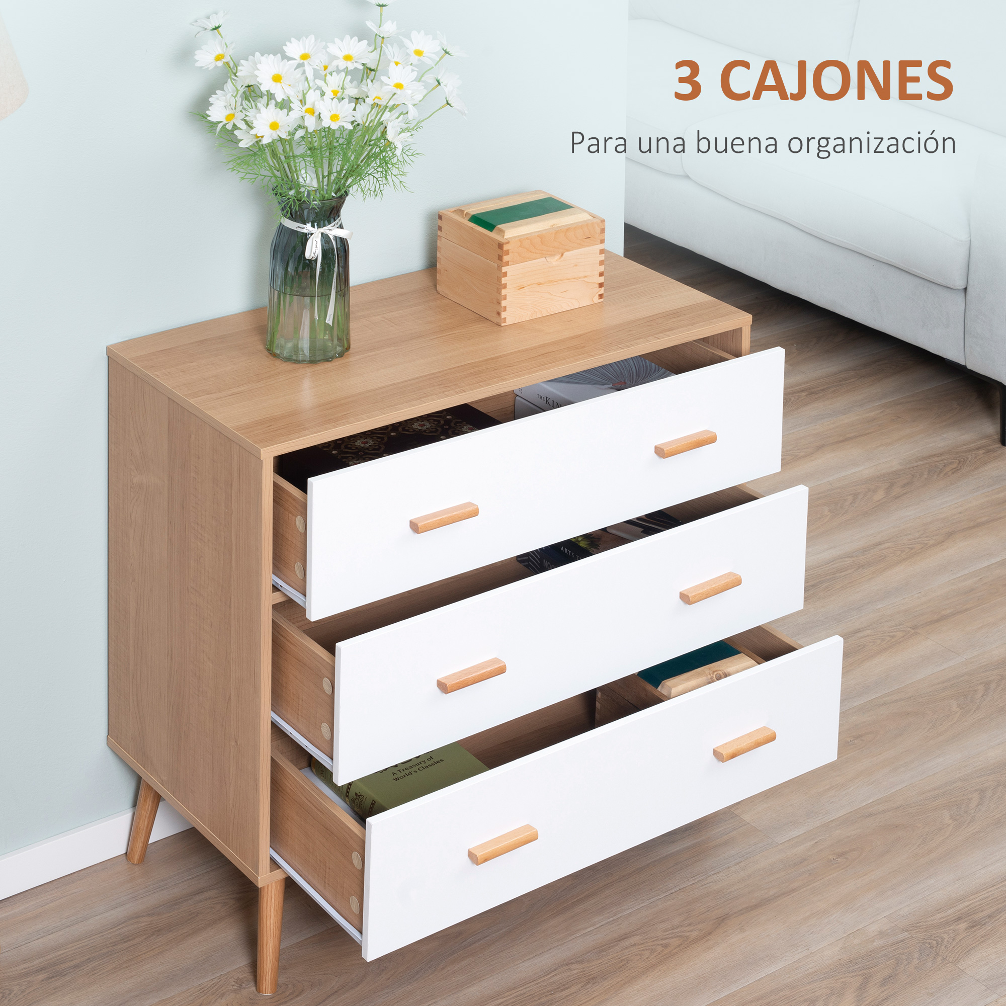 Una mesita de noche de madera con tres cajones blancos y tiradores de madera.