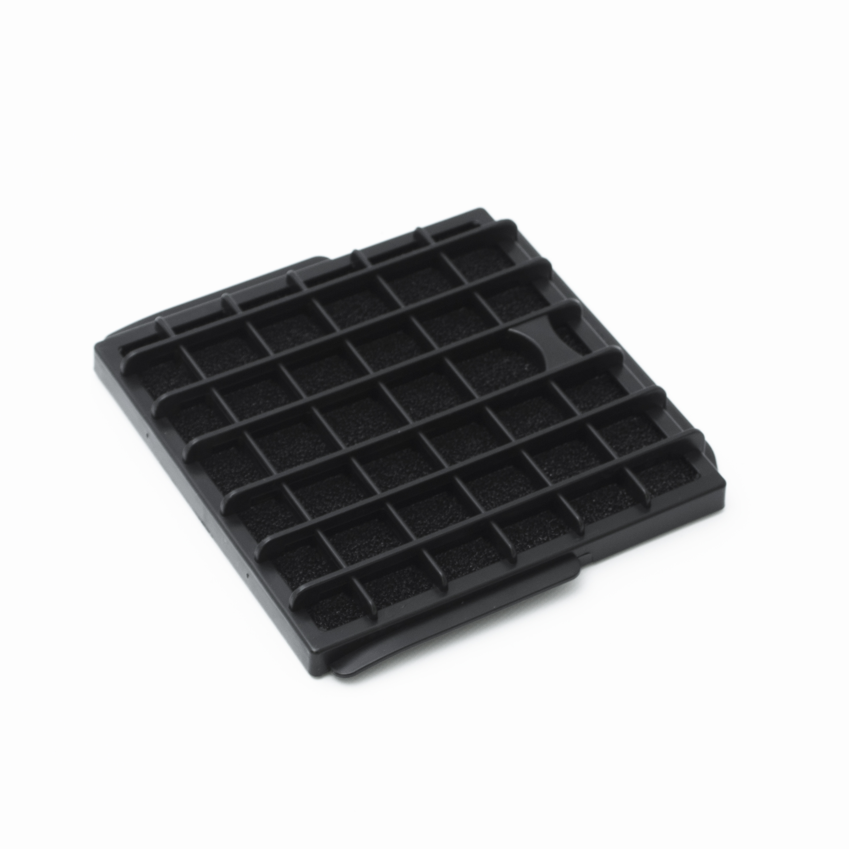 A black plastic filter with a grid pattern and foam.