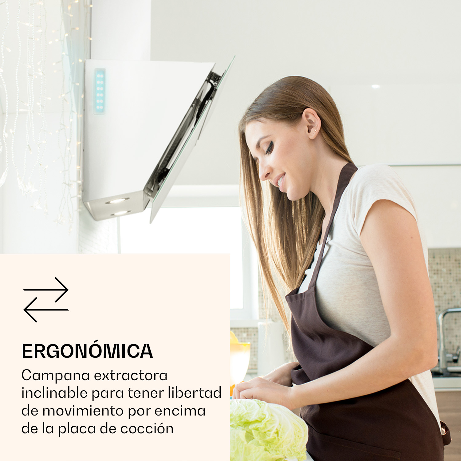 Una mujer en una cocina prepara comida. Se ve una campana extractora con frente de cristal.