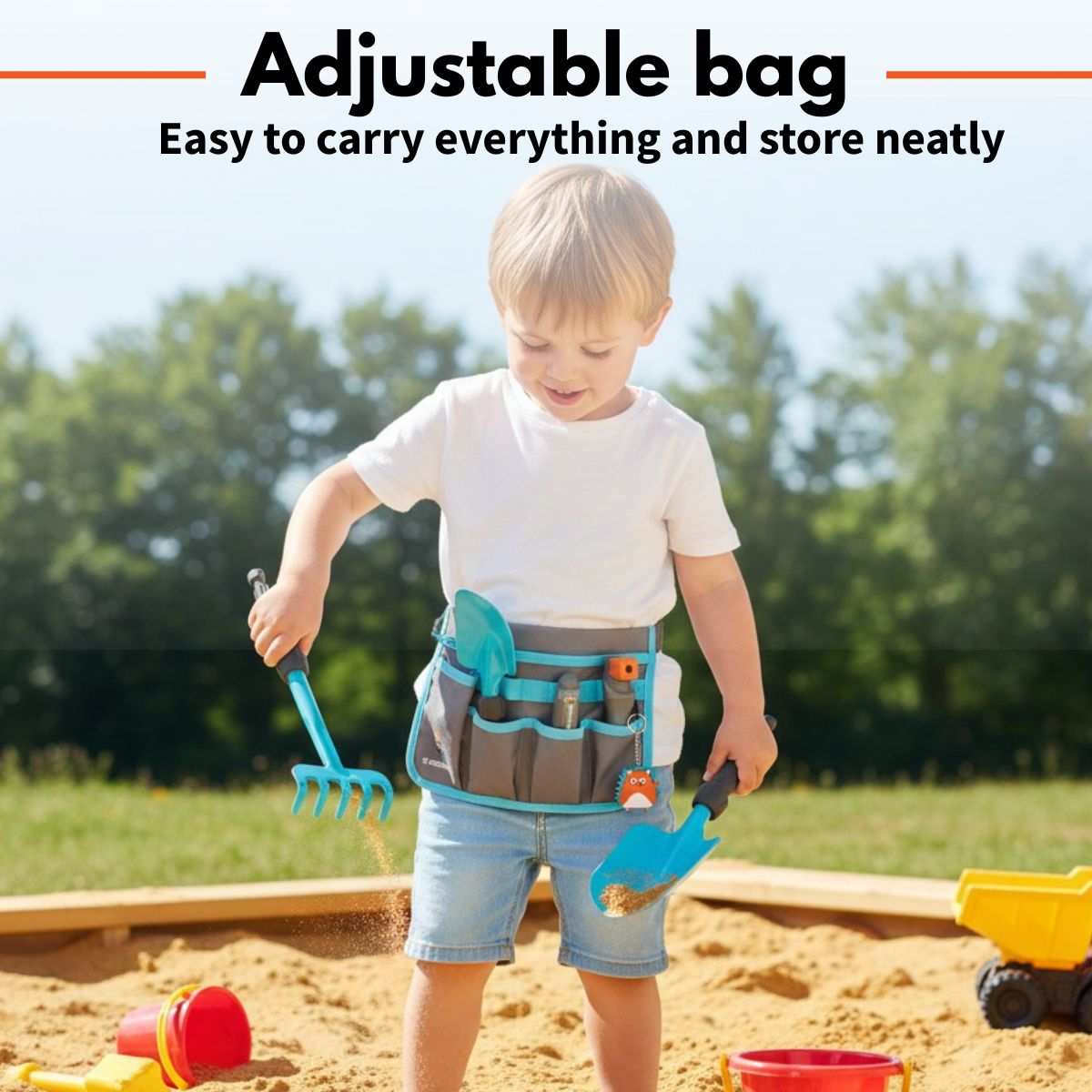 A boy wearing a tool belt plays in a sandbox, holding a rake and a shovel.