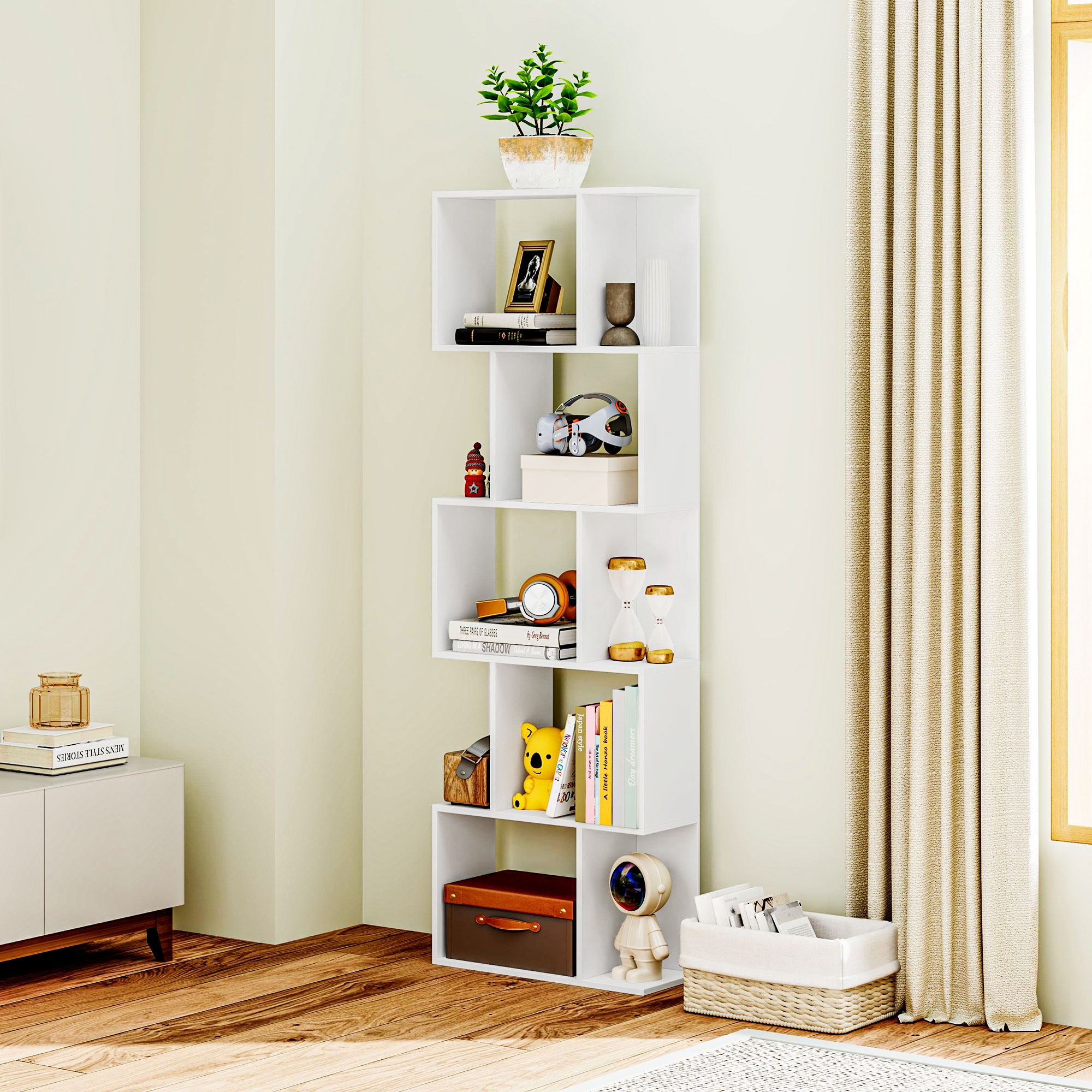 Un estante blanco con libros, plantas y objetos decorativos en una habitación luminosa.