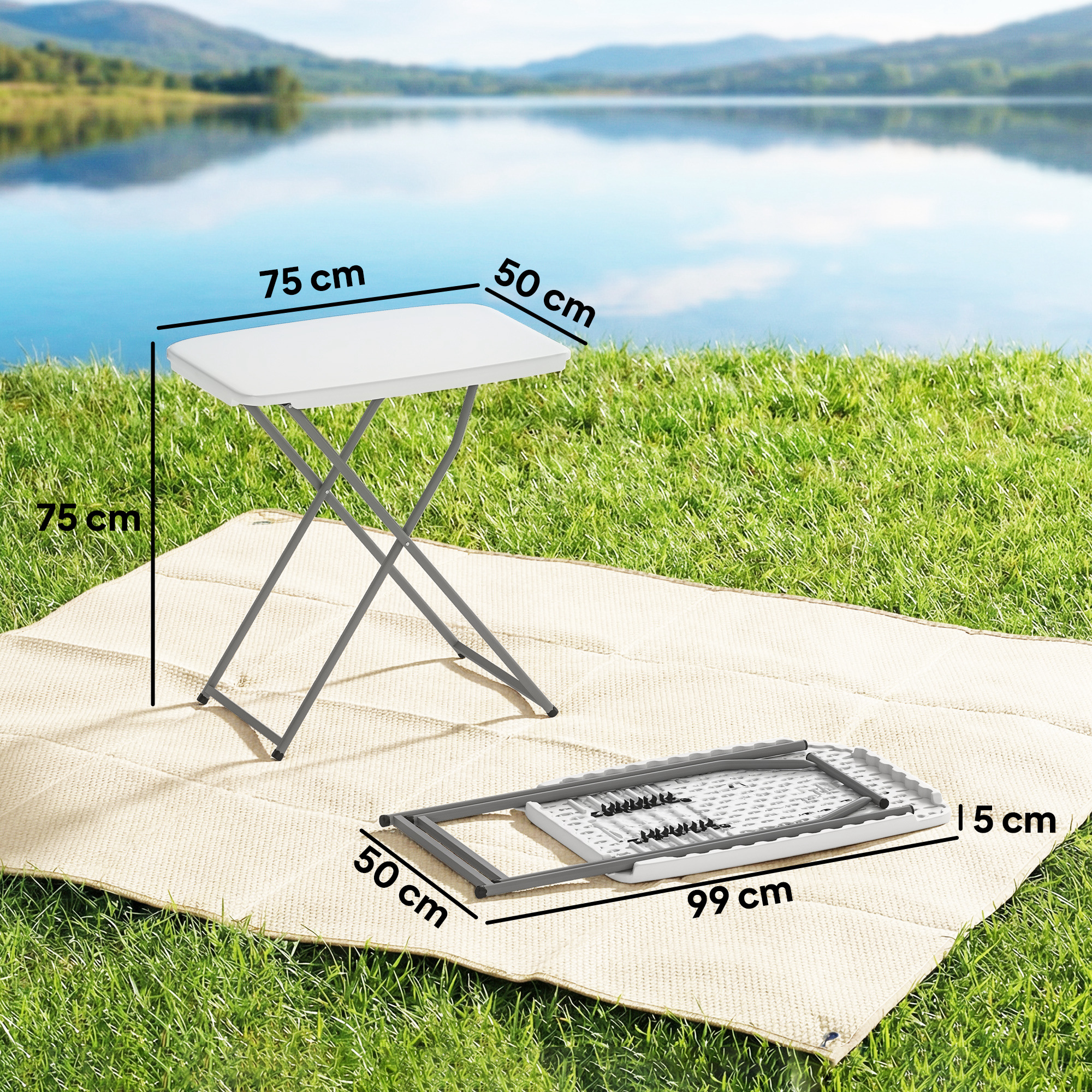 Una mesa plegable blanca está sobre una manta en el césped, junto a una plegada.