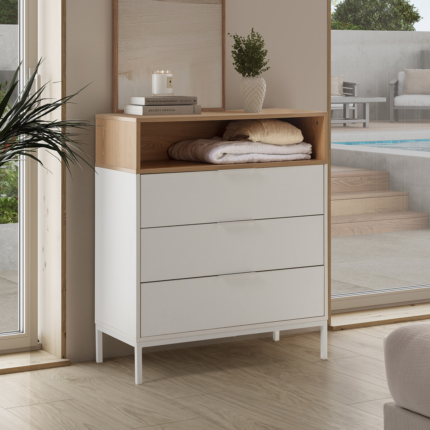 Cómoda moderna de tres cajones, elementos de madera y blancos, con piscina cerca.
