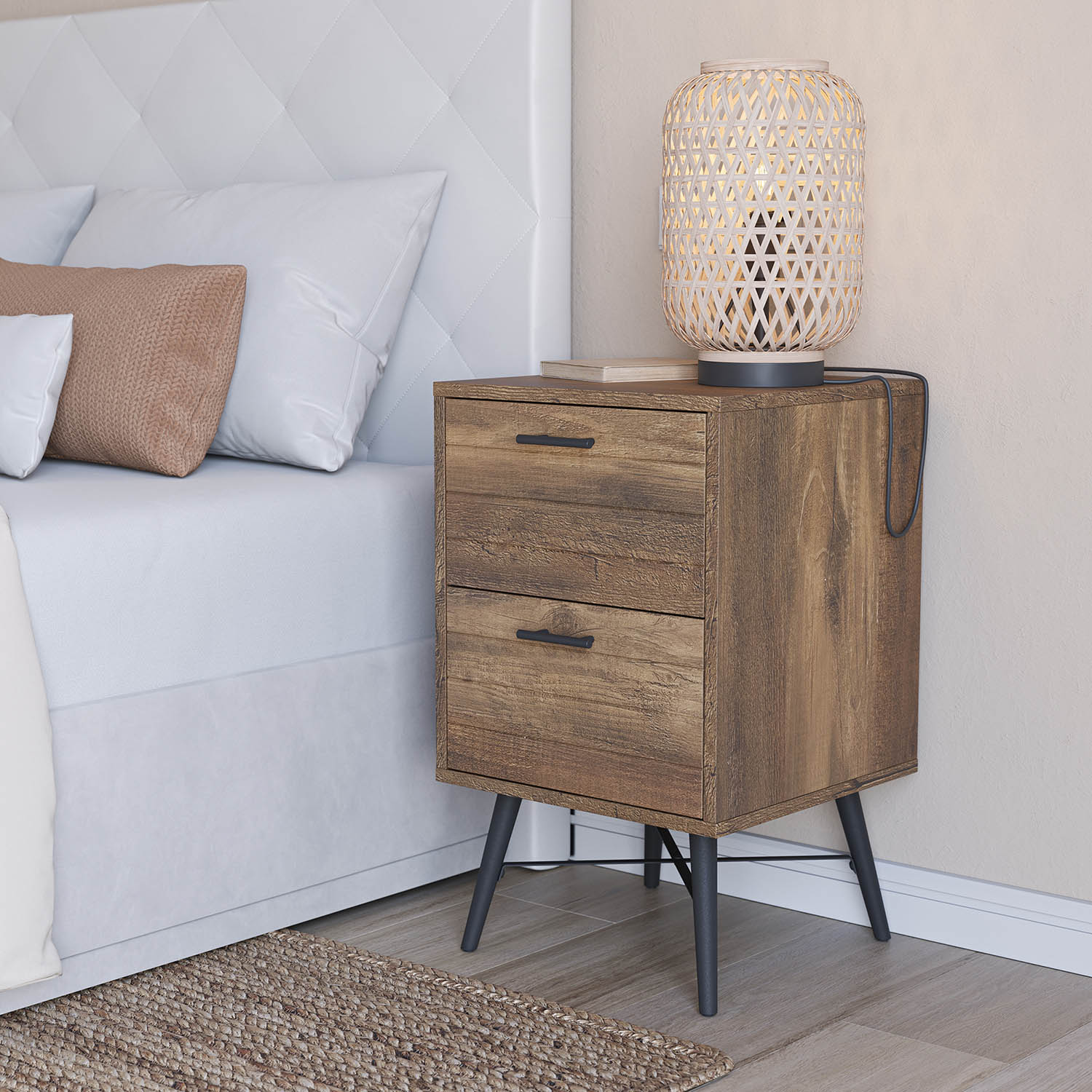 Mesita de noche de madera con dos cajones junto a una cama con almohadas blancas.