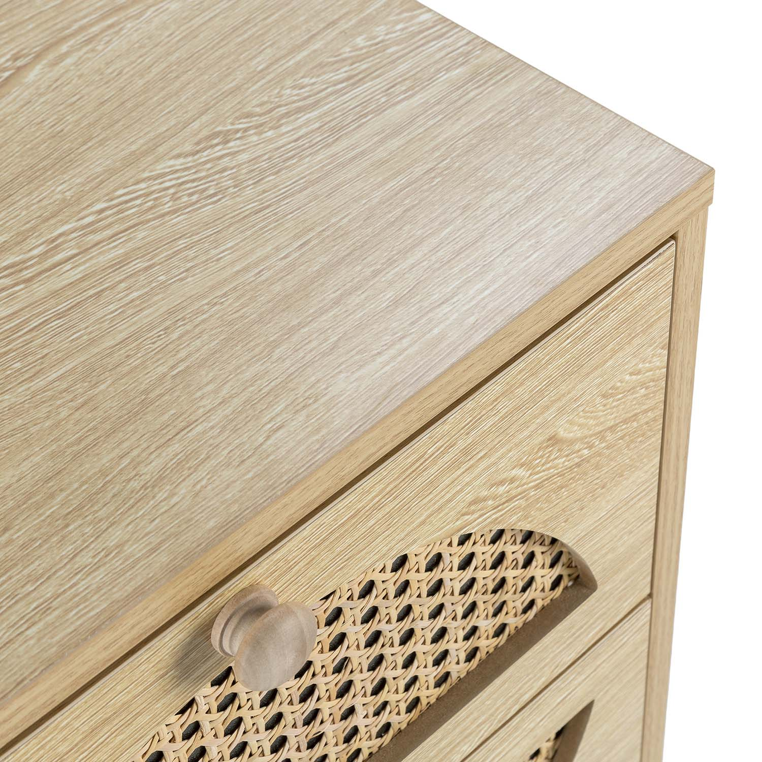 Cómoda de madera clara con inserción de ratán y pomo redondo.