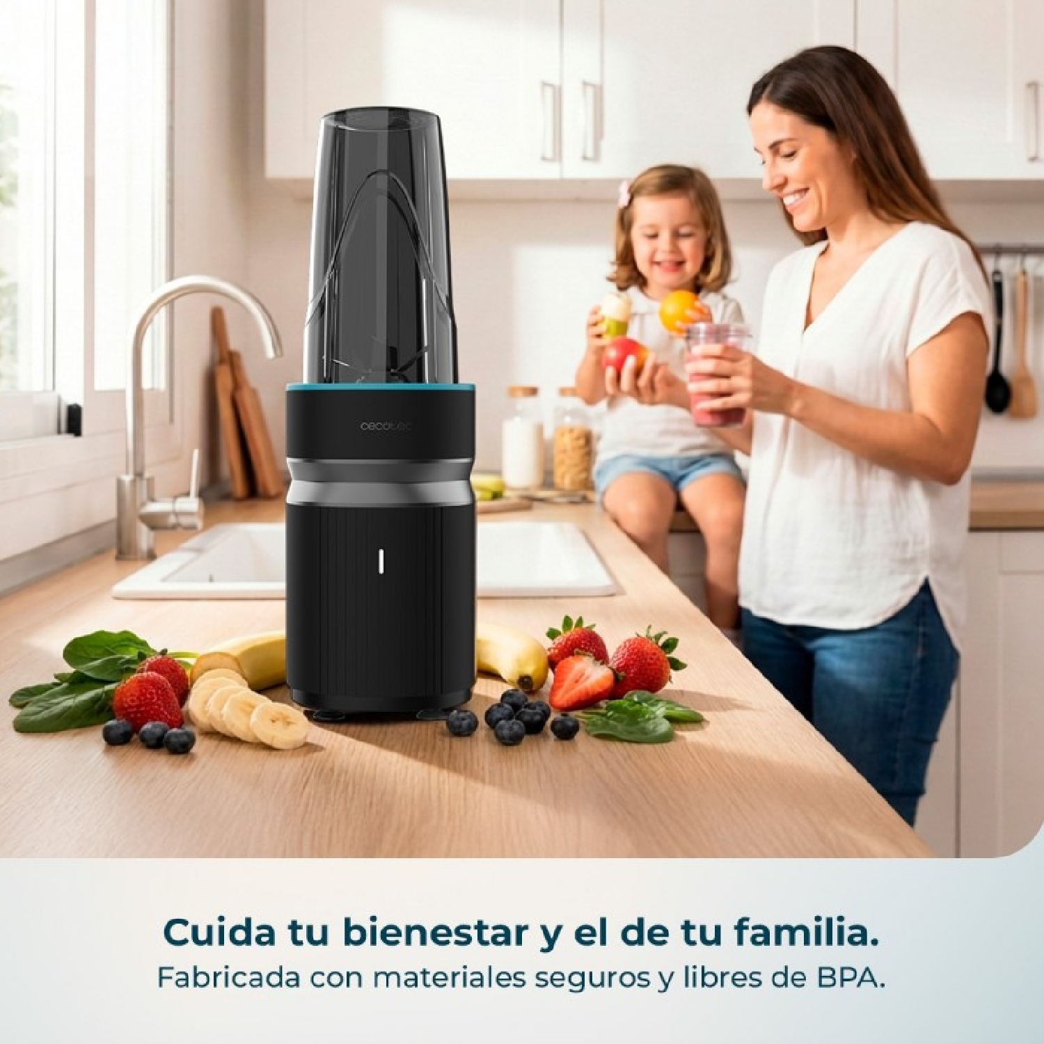 Una donna e un bambino in cucina con frullatore e frutta.