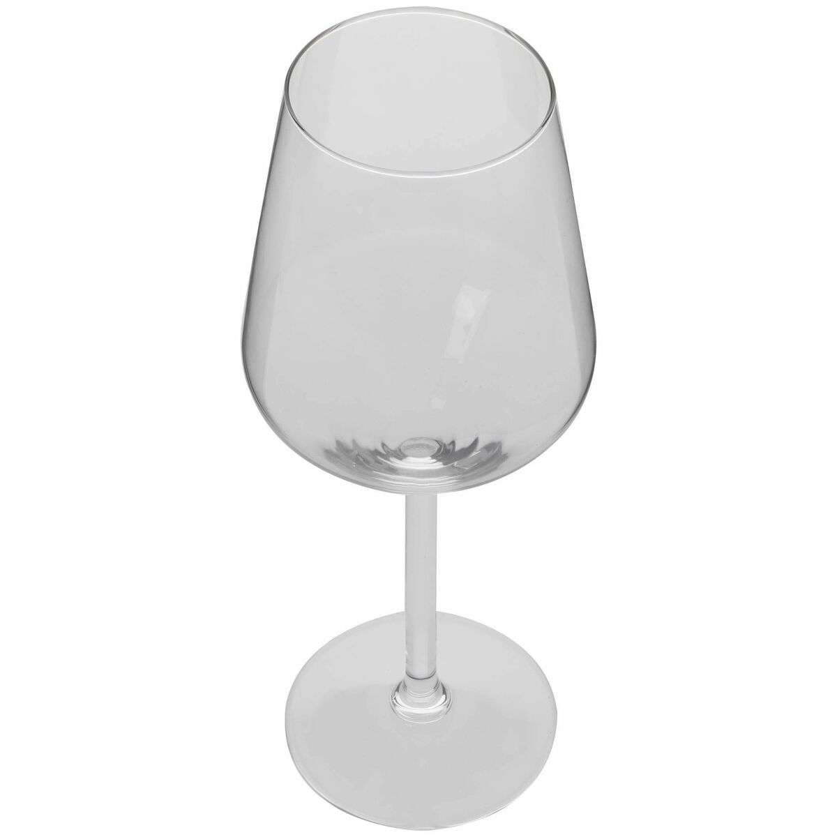 An empty, clear wine glass on a round base stands against a white background.