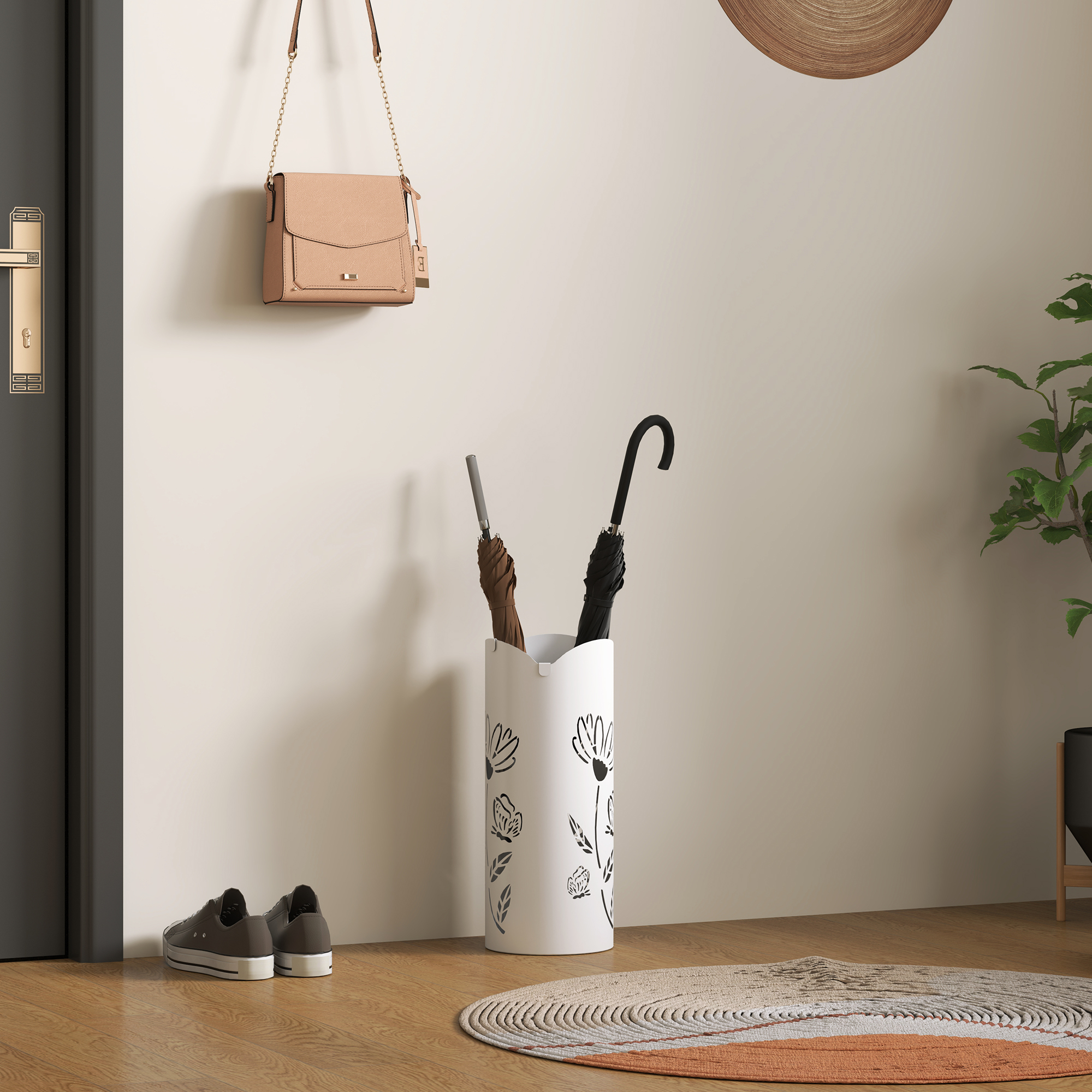 Un bolso beige colgado en la pared, junto a él un paragüero blanco con dos paraguas.