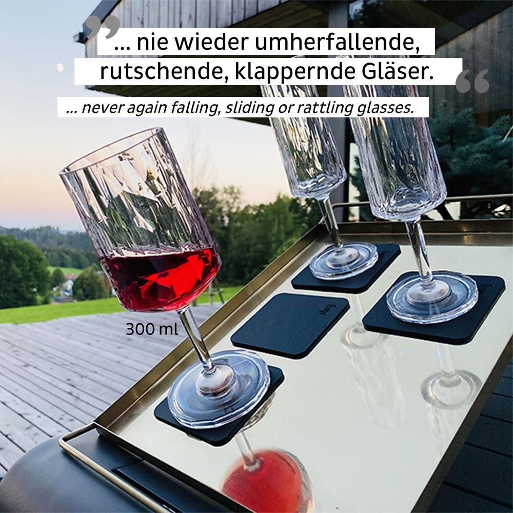 Trois verres de vin rouge sur un plateau. Un verre est plein, deux sont vides.