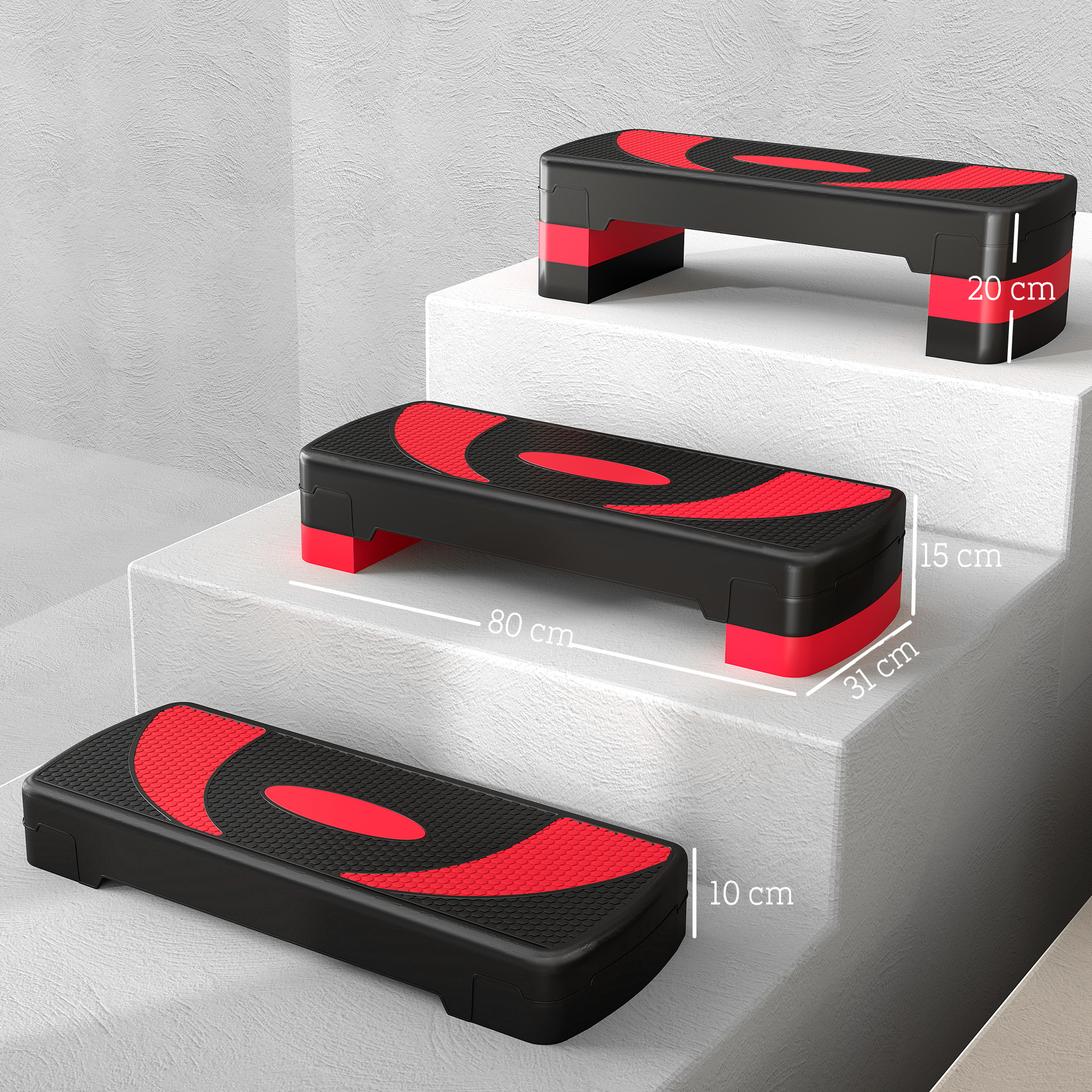 Tres plataformas de step negras con acentos rojos sobre escalones blancos.
