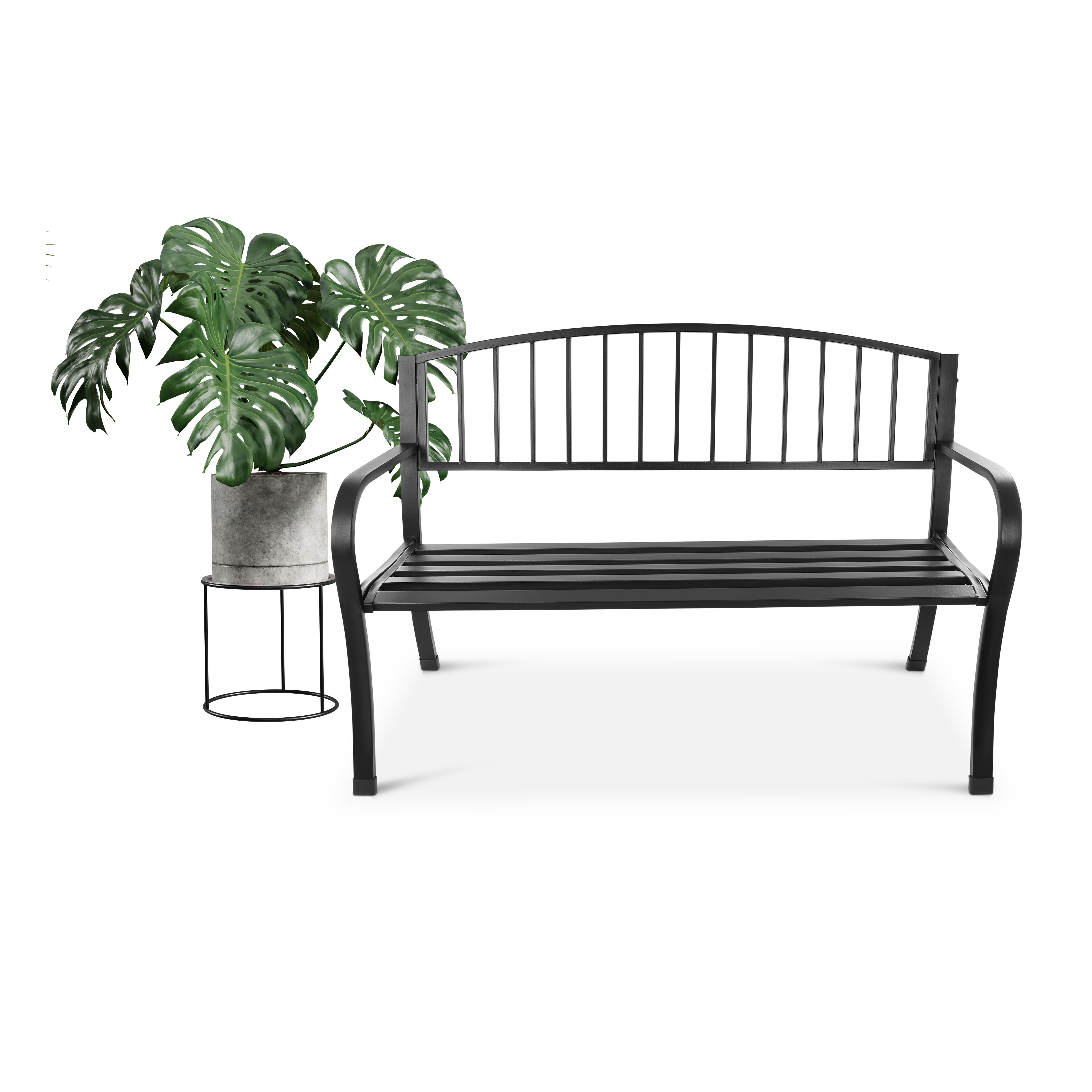 Czarna metalowa ławka ogrodowa obok rośliny Monstera w doniczce.