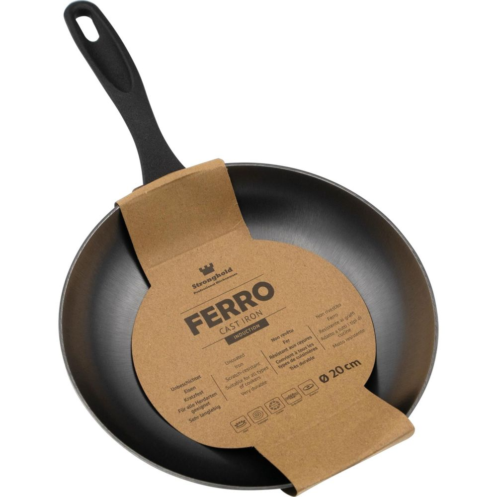 Une poêle en fonte noire avec manche noir et carton marron. Ø 20 cm.