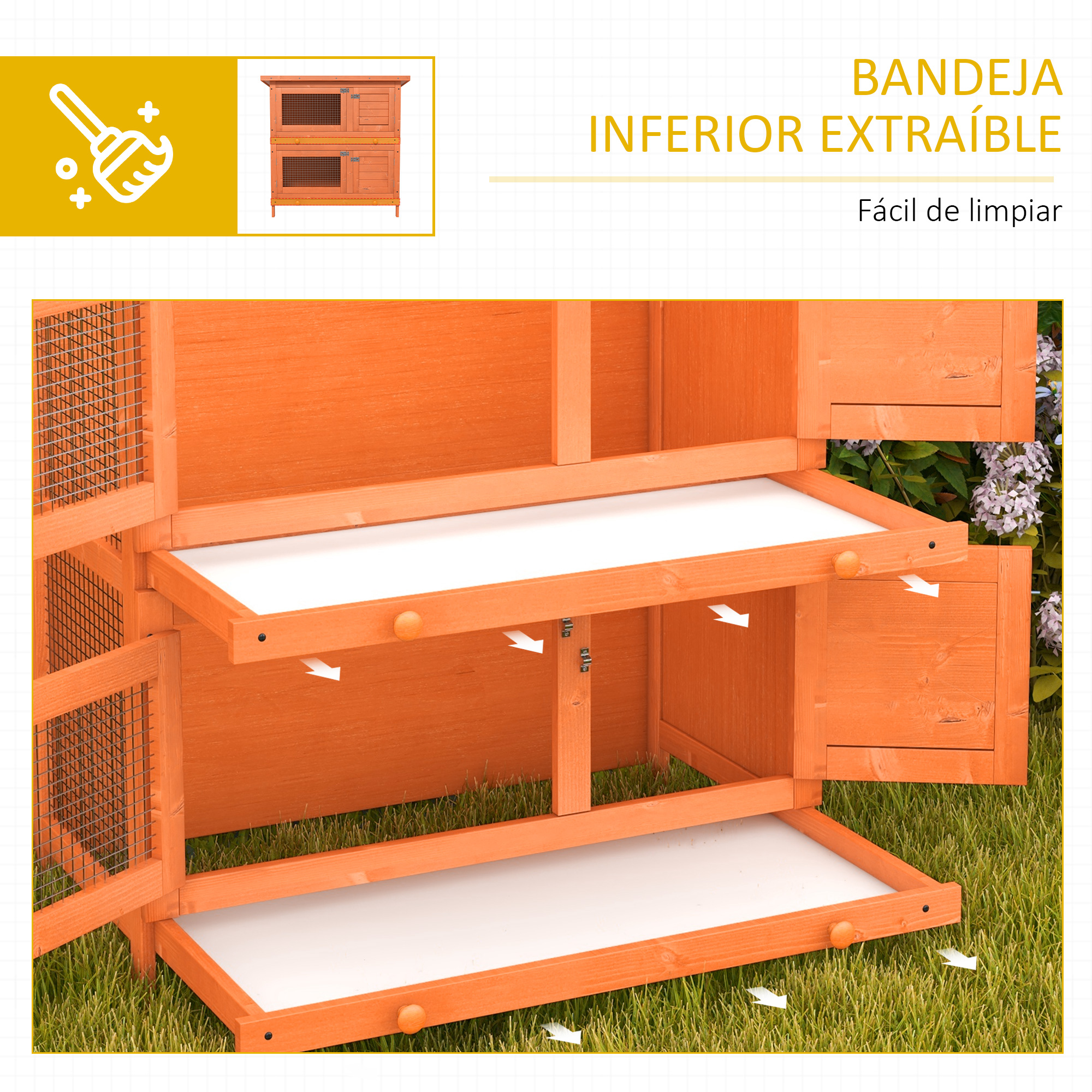 Una conejera naranja con bandejas extraíbles sobre césped.