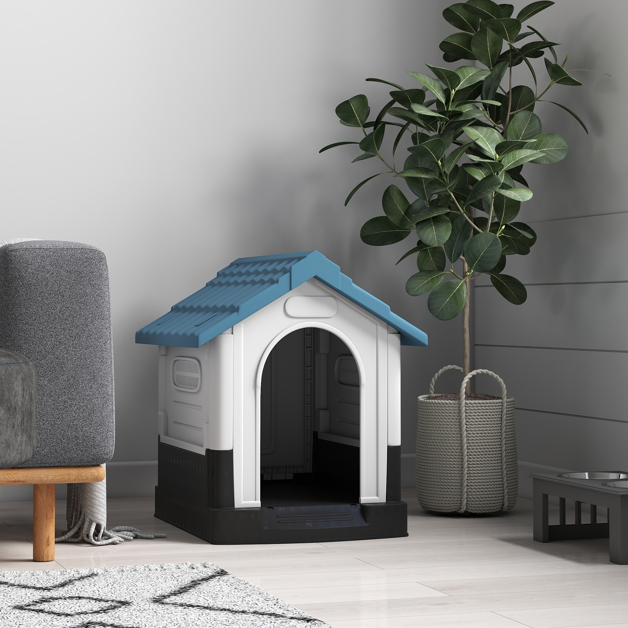 Una caseta para perros blanca y negra con techo azul junto a una planta en maceta.