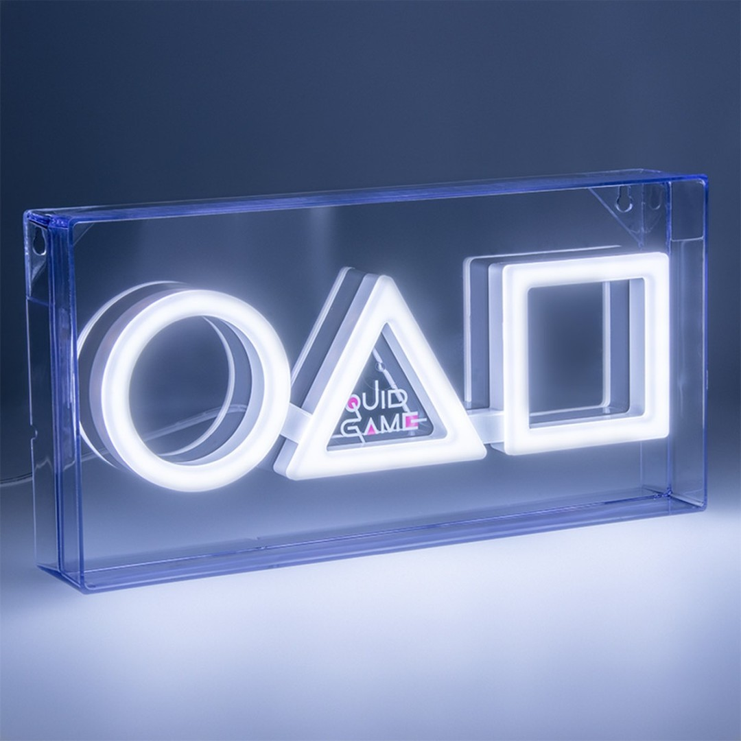 Lampa neonowa z symbolami koła, trójkąta i kwadratu w przezroczystej obudowie.