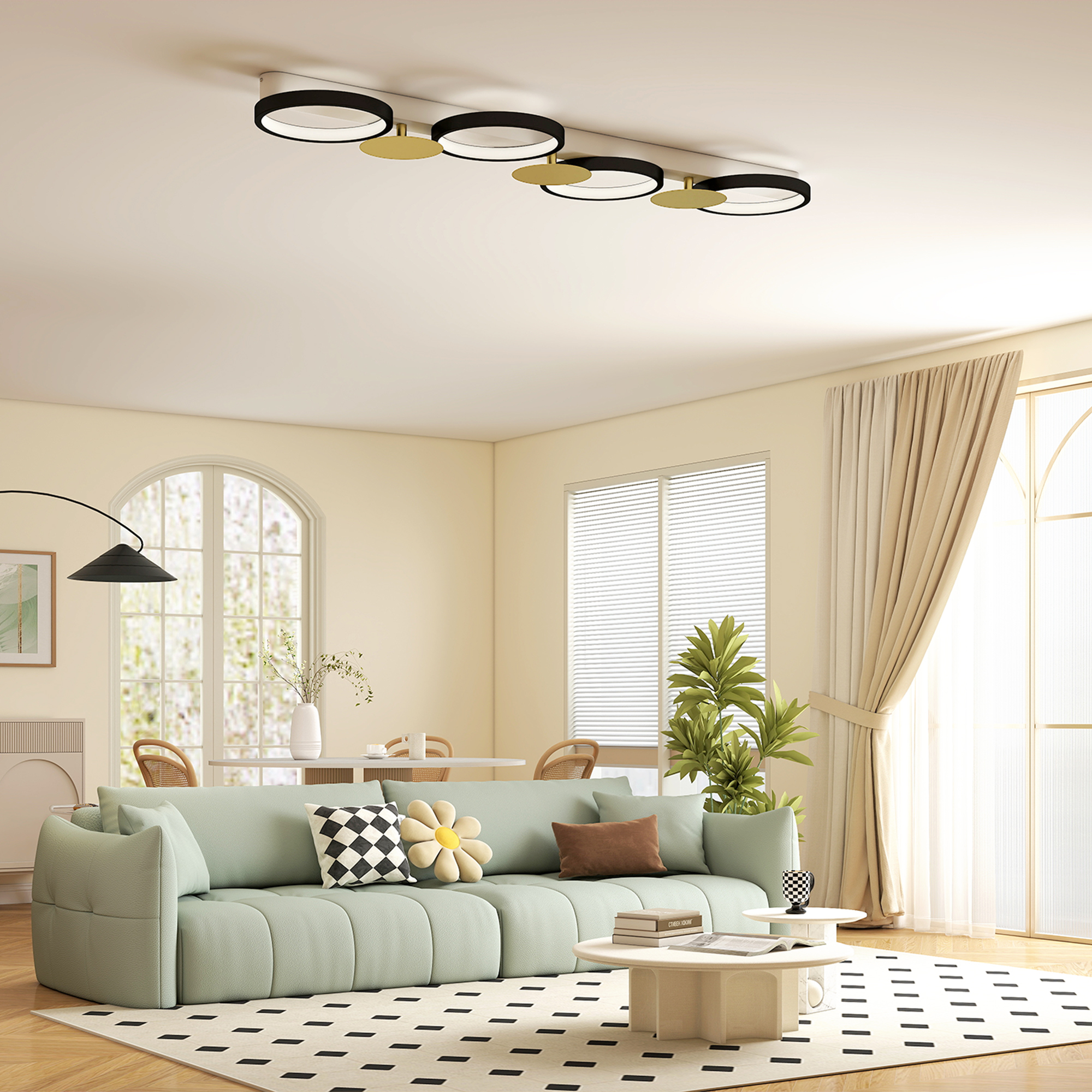 Una sala de estar luminosa con sofá verde menta, alfombra y ventanas.