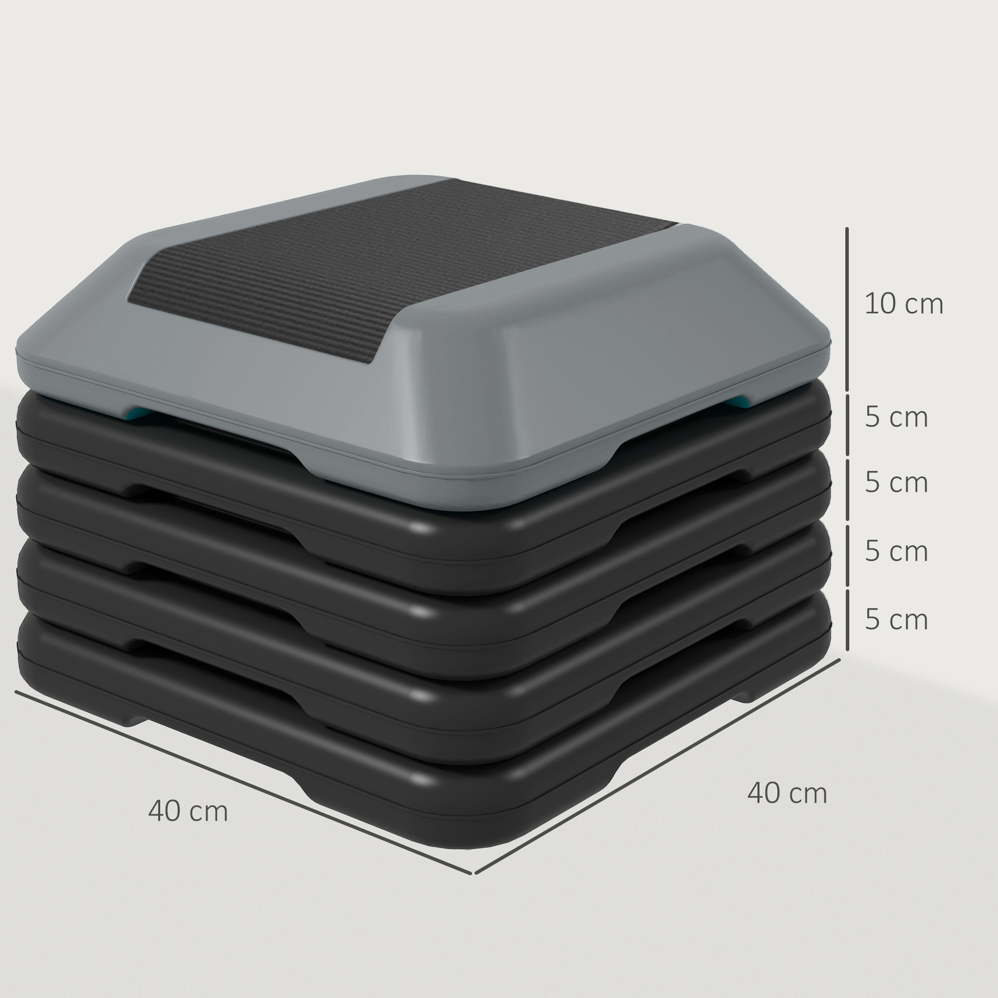 Una plataforma de step aeróbico apilada con parte superior gris y bases negras.