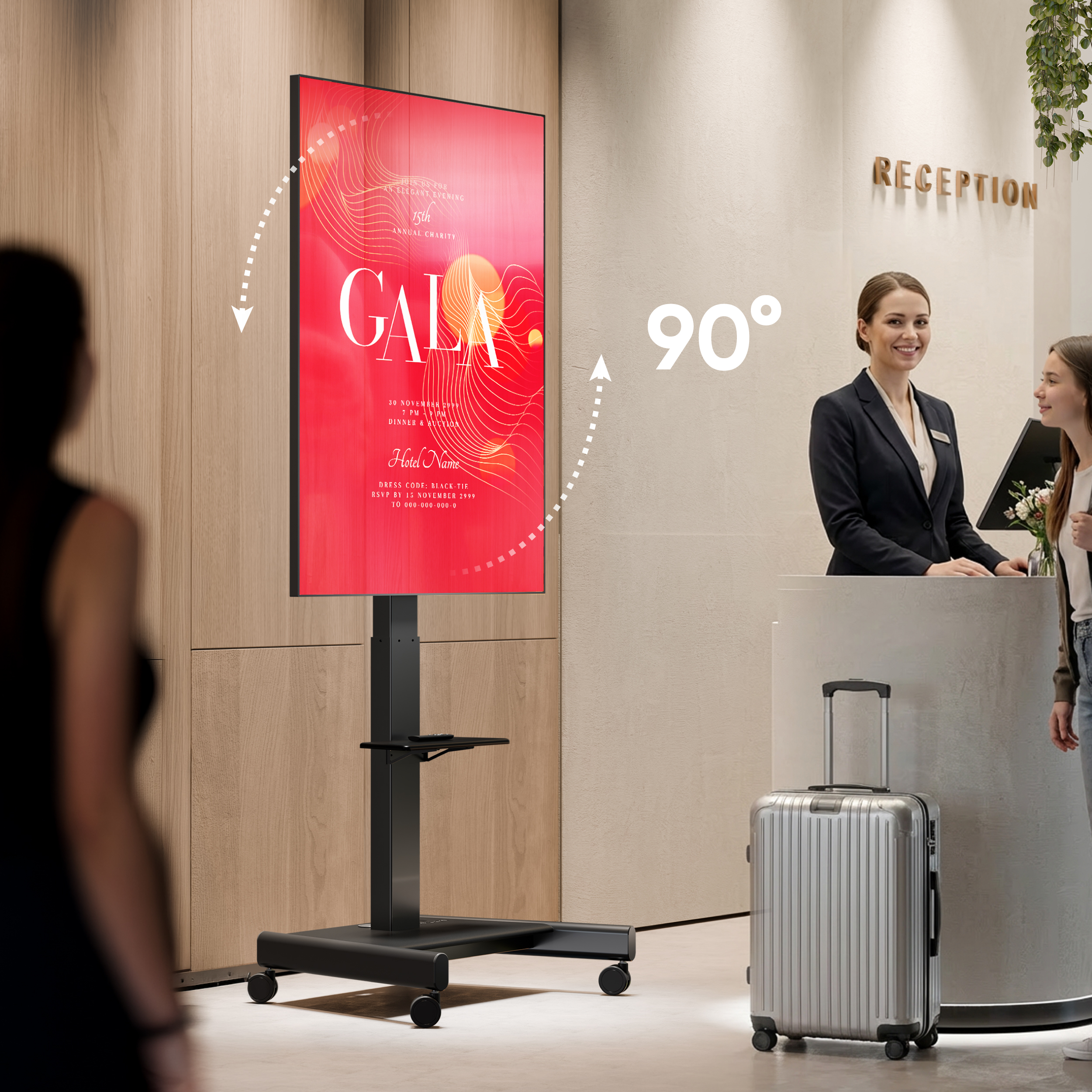 Uno schermo digitale pubblicizza 'Gala' vicino a una reception con due donne.