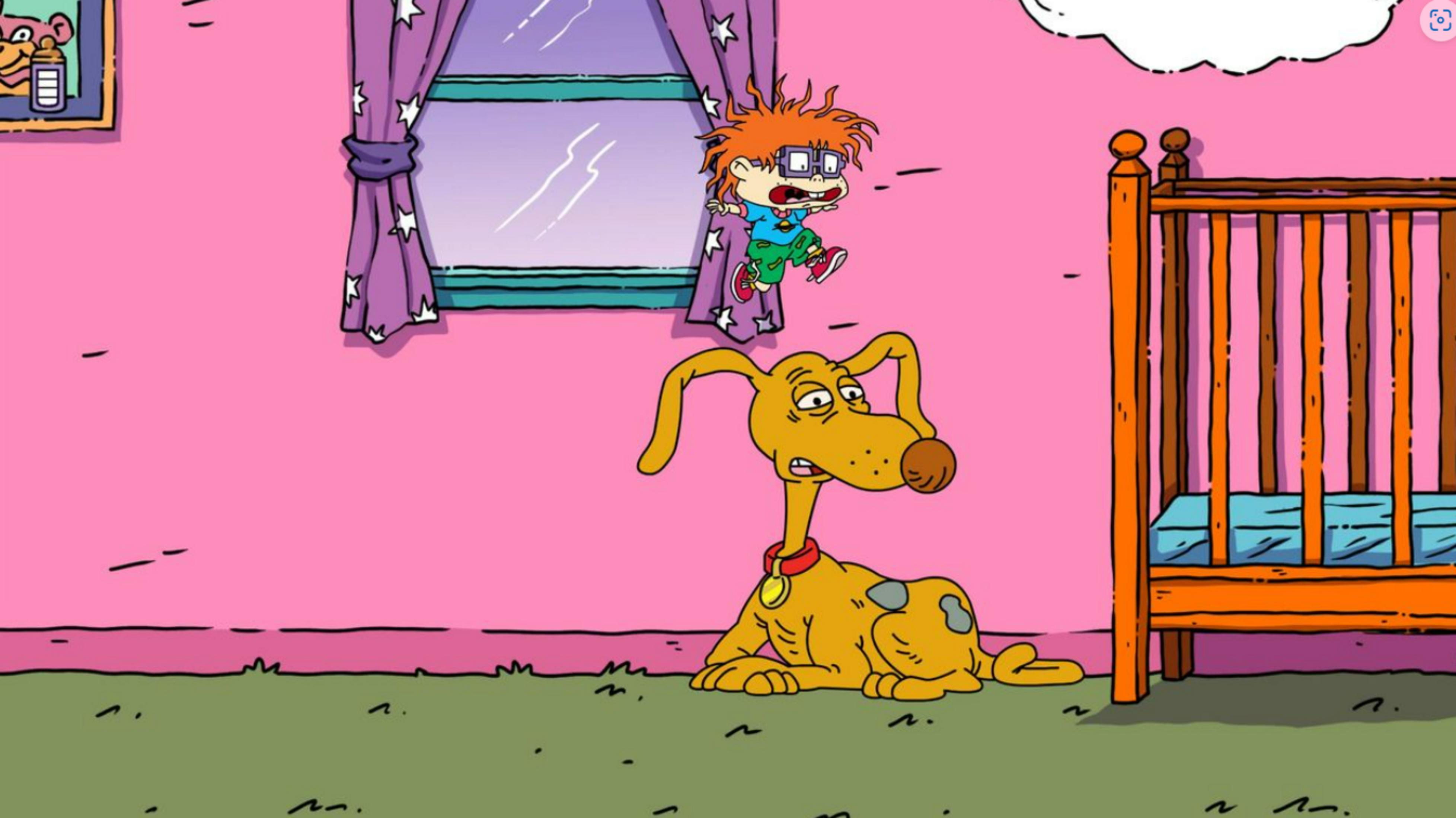 Ein Junge mit roten Haaren springt neben einem gelben Hund und einem Kinderbett.