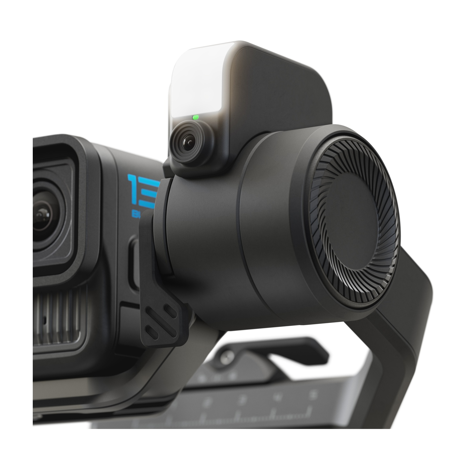 Ein schwarzer Gimbal mit einem Objektiv und einem beleuchteten Aufsatz.