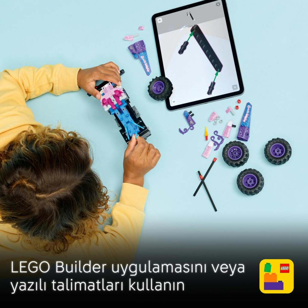 Dziecko buduje auto Lego wg instrukcji na tablecie. Części i koła leżą wokół.