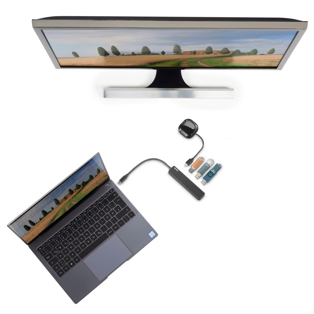 Laptop, monitor, hub i dyski USB są ułożone na białej powierzchni.