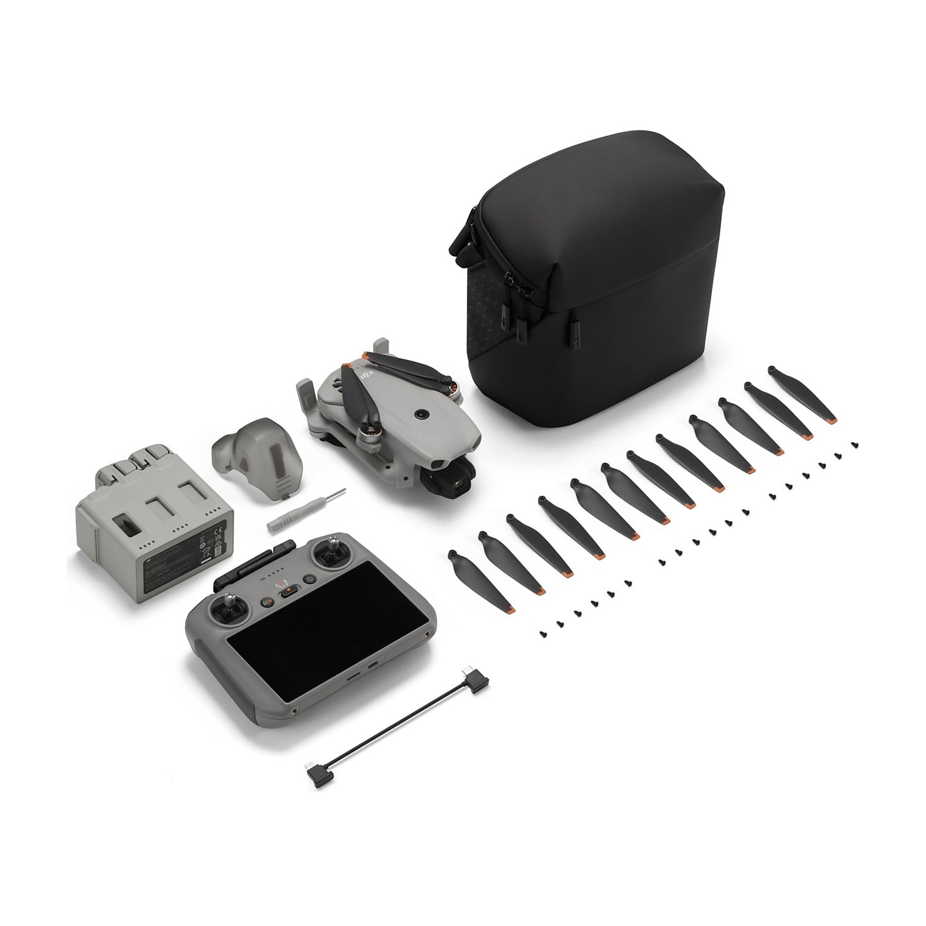 Kit de mini dron gris con mando, batería, hélices y bolsa.