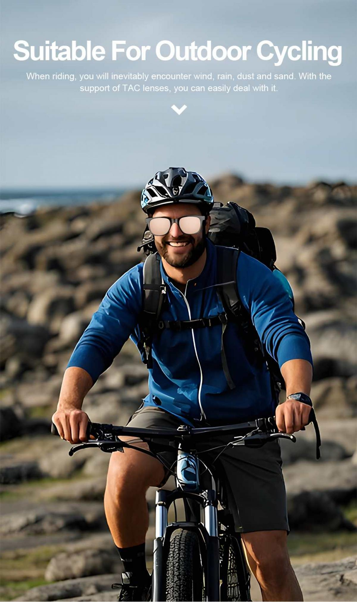 Mann auf Fahrrad in blauer Jacke, Helm und Sonnenbrille, Felsen im Hintergrund.
