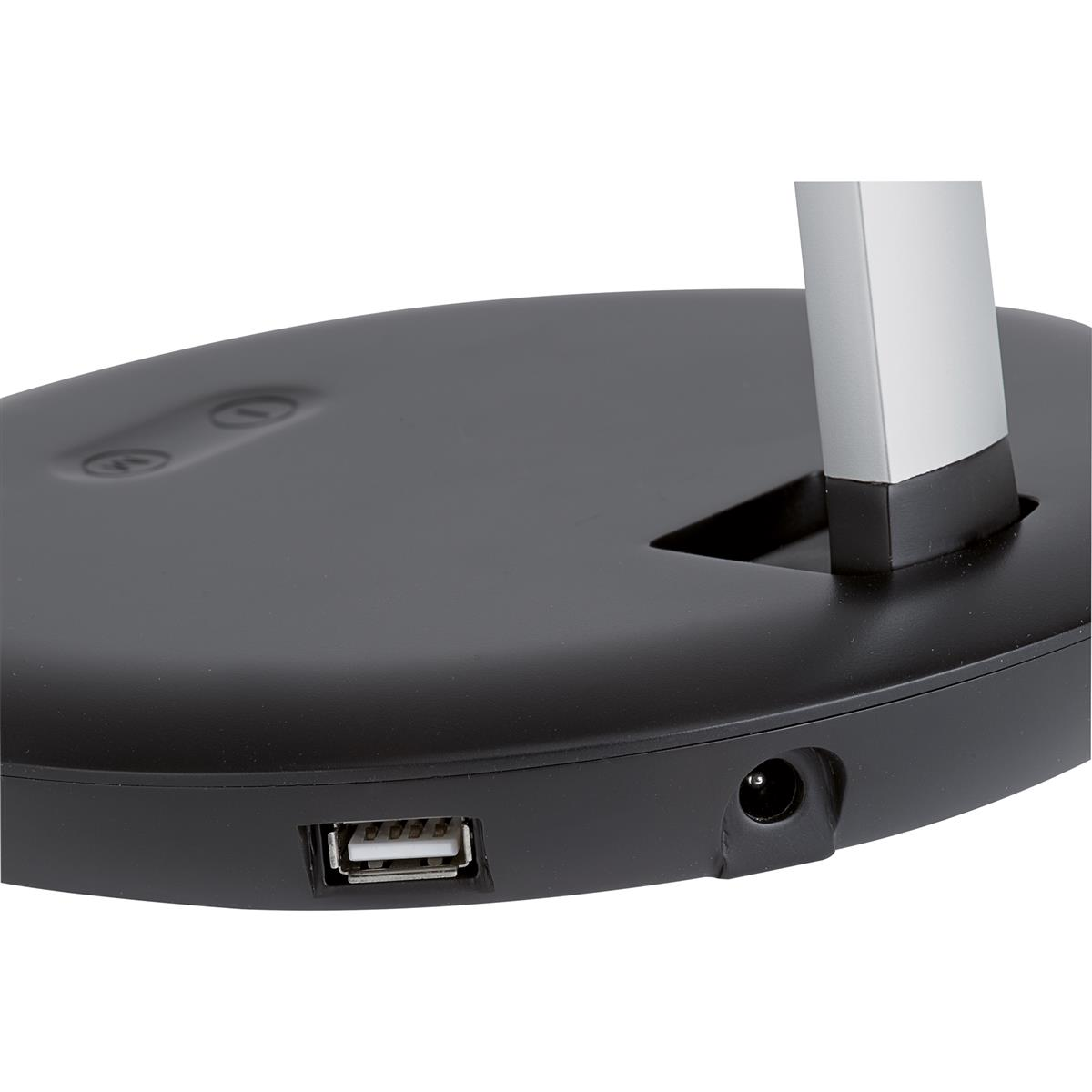 Primer plano de la base negra de una lámpara con puertos USB y de alimentación.
