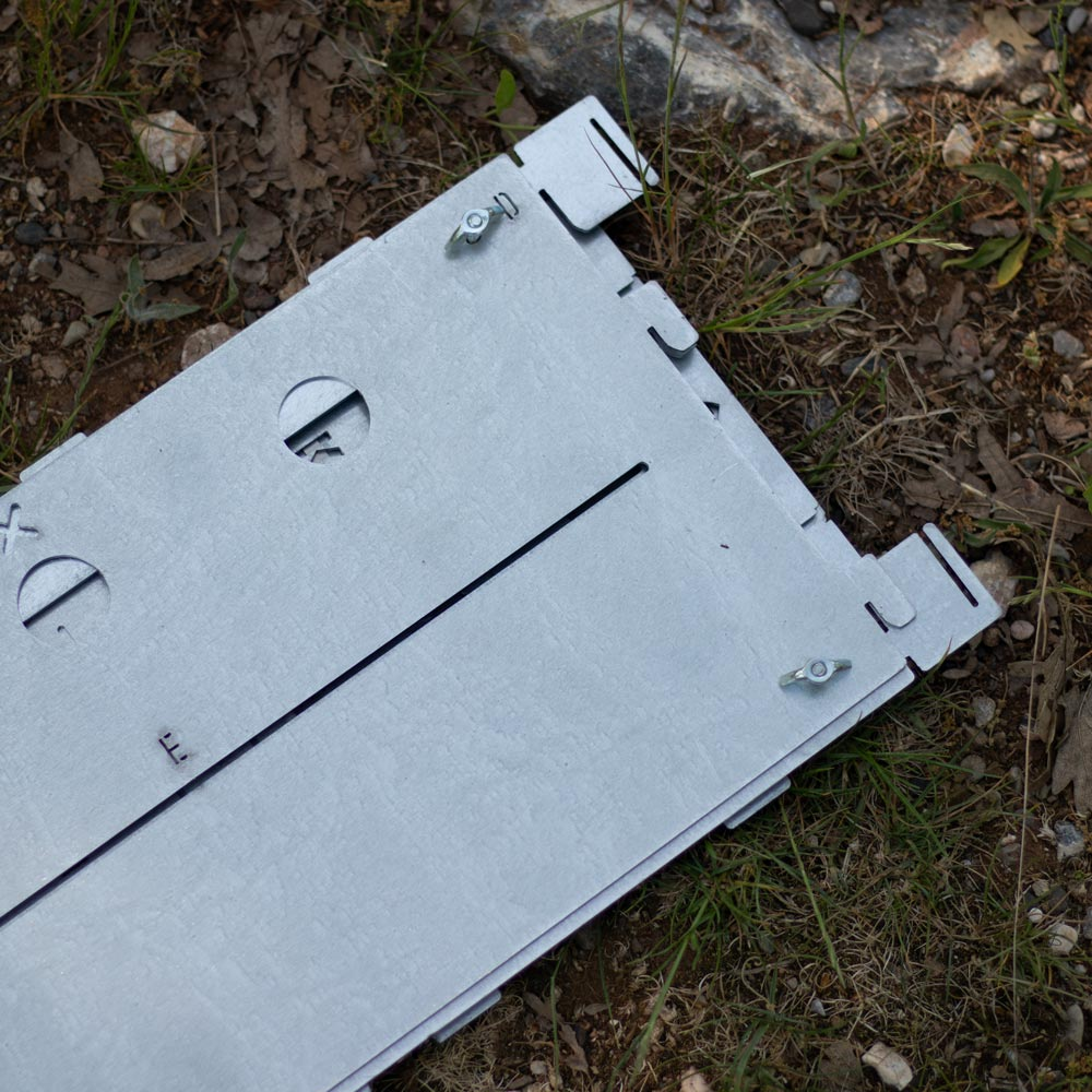 Vidalarla metal plakalar kuru zeminde ve çimlerin üzerinde duruyor.