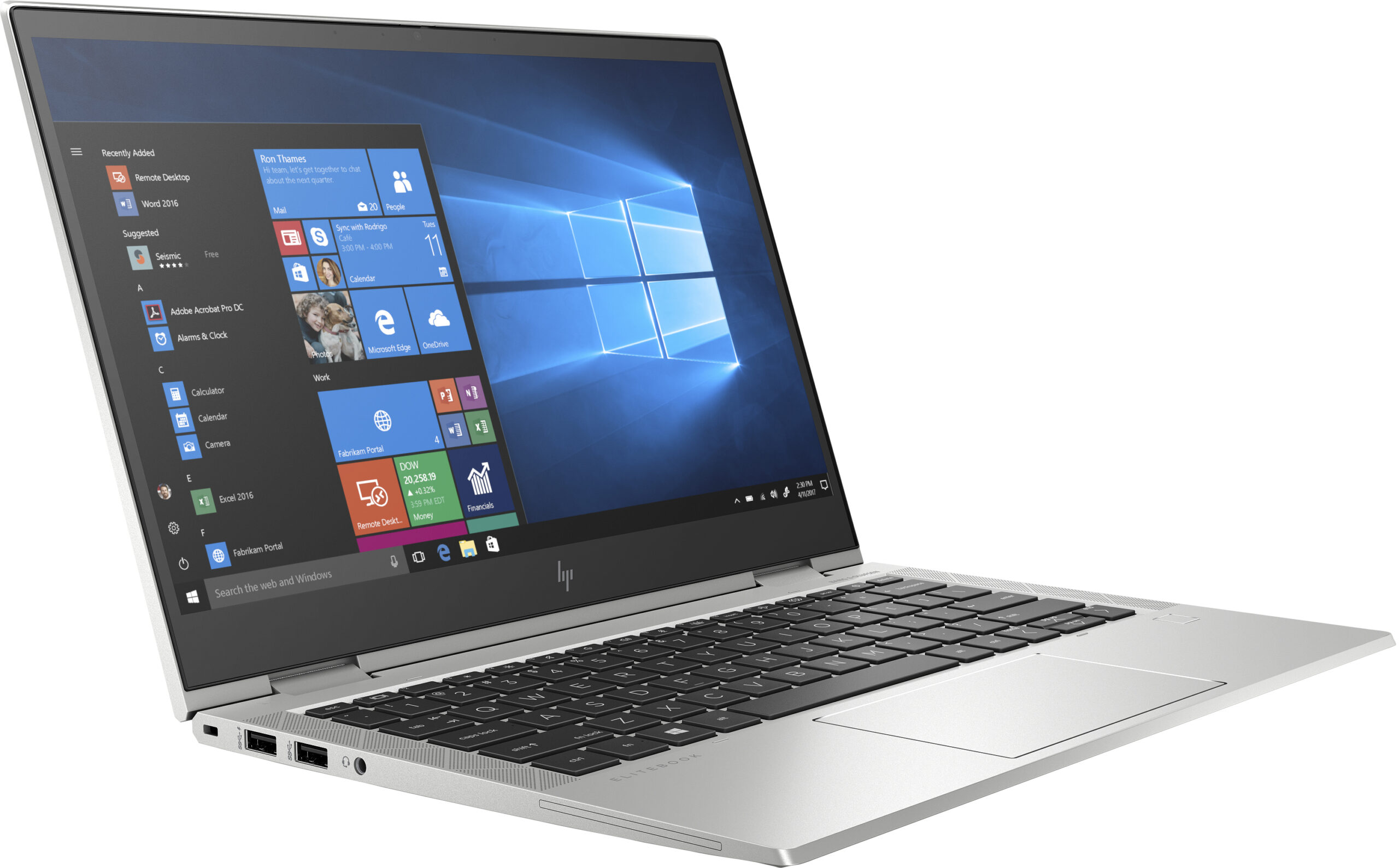 Un portátil plateado con la pantalla abierta, mostrando Windows 10 y un teclado.