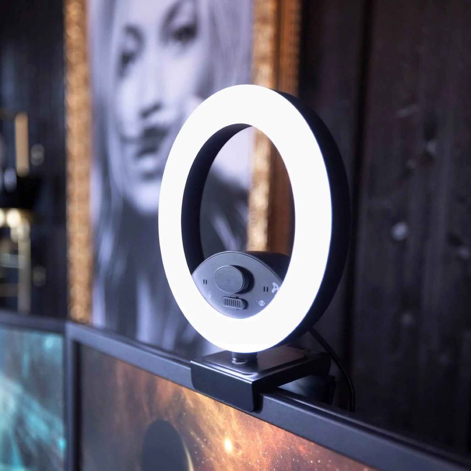 Een zwart ringlicht met wit licht is aan een monitor bevestigd.