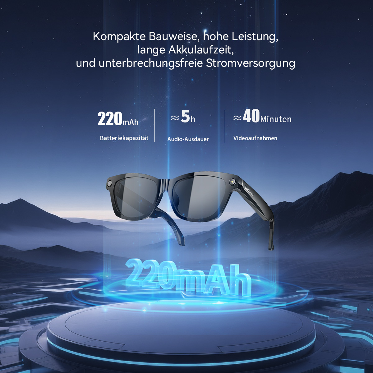 Schwarze Brille mit 220mAh Akku. Steht auf einem Podest vor Bergen.